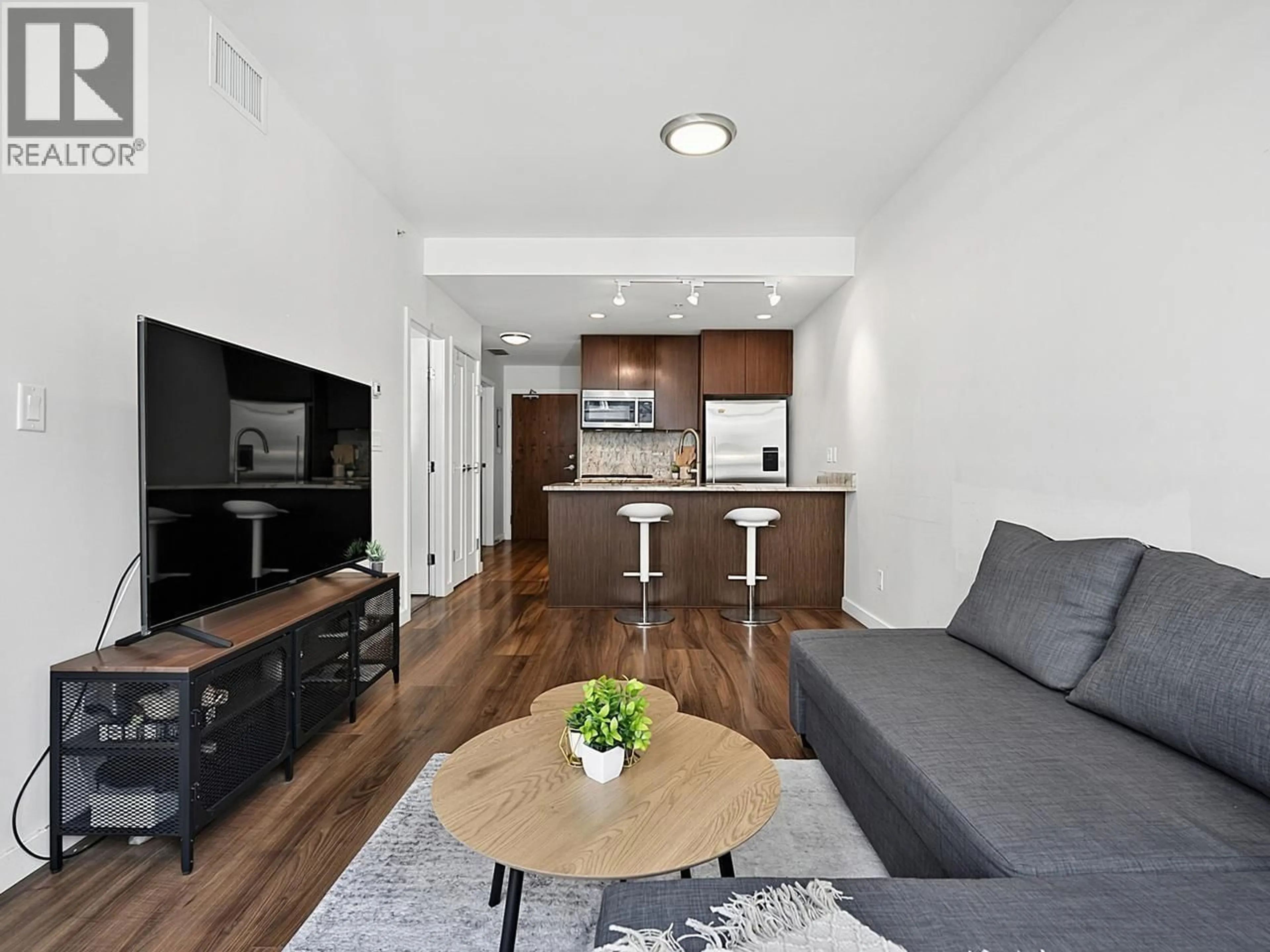 Living room with furniture, wood/laminate floor for 510 - 8628 HAZELBRIDGE WAY, Richmond British Columbia V6X0R5