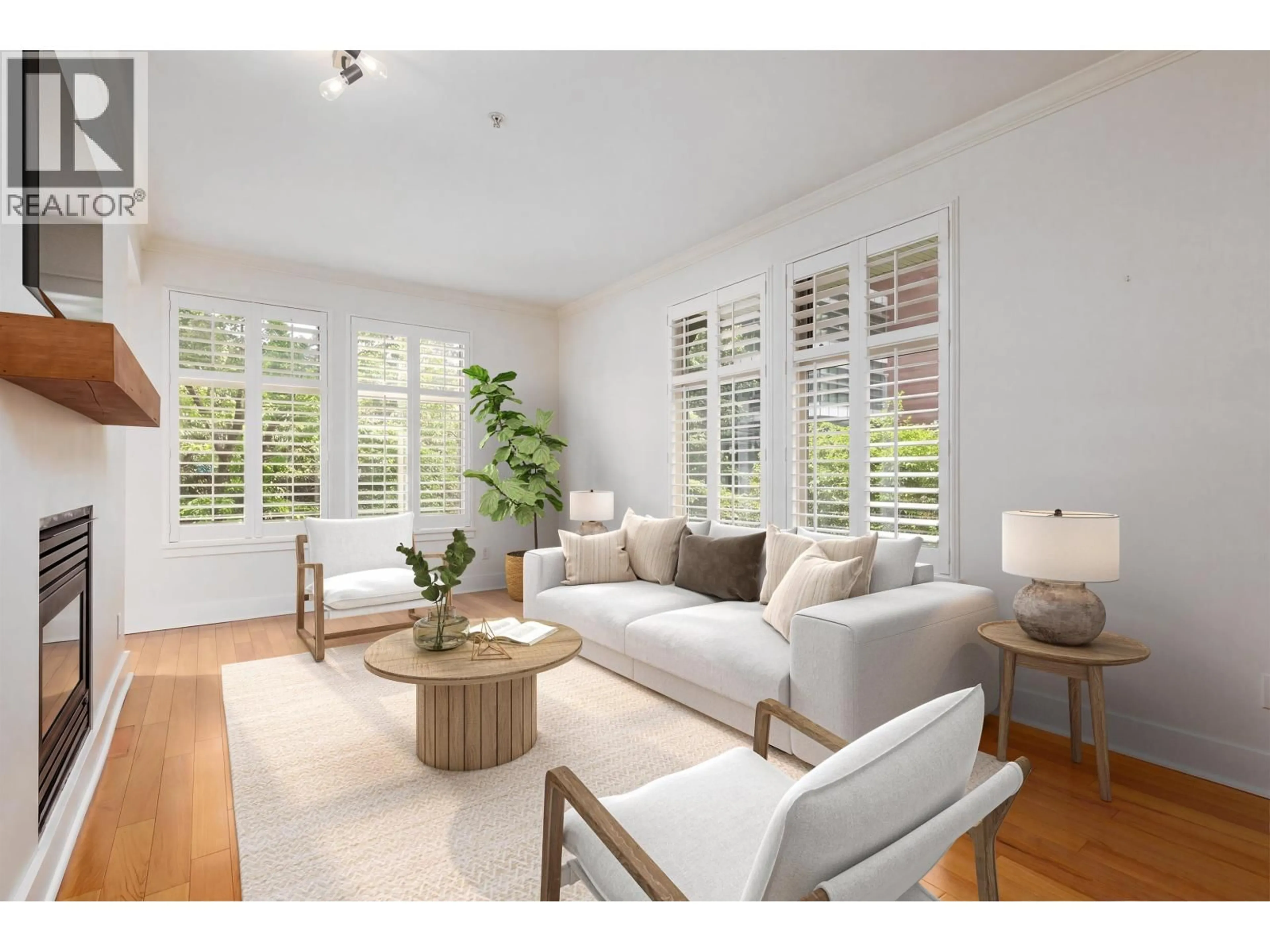 Living room with furniture, wood/laminate floor for 201 - 118 22ND STREET, North Vancouver British Columbia V7M1Z9