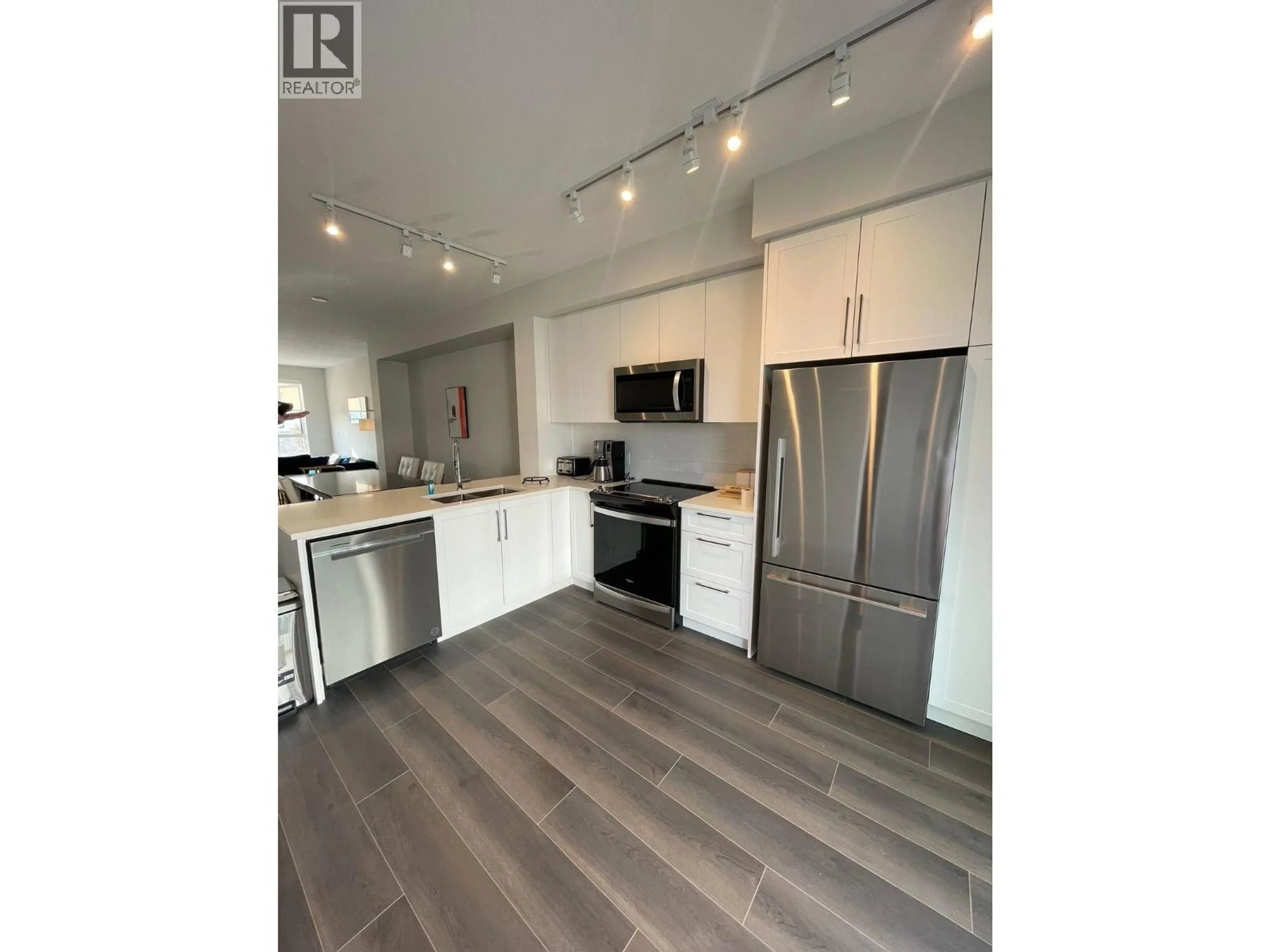 Open concept kitchen, wood/laminate floor for 2 - 4745 SPRUCE WAY, Delta British Columbia V4M0E8
