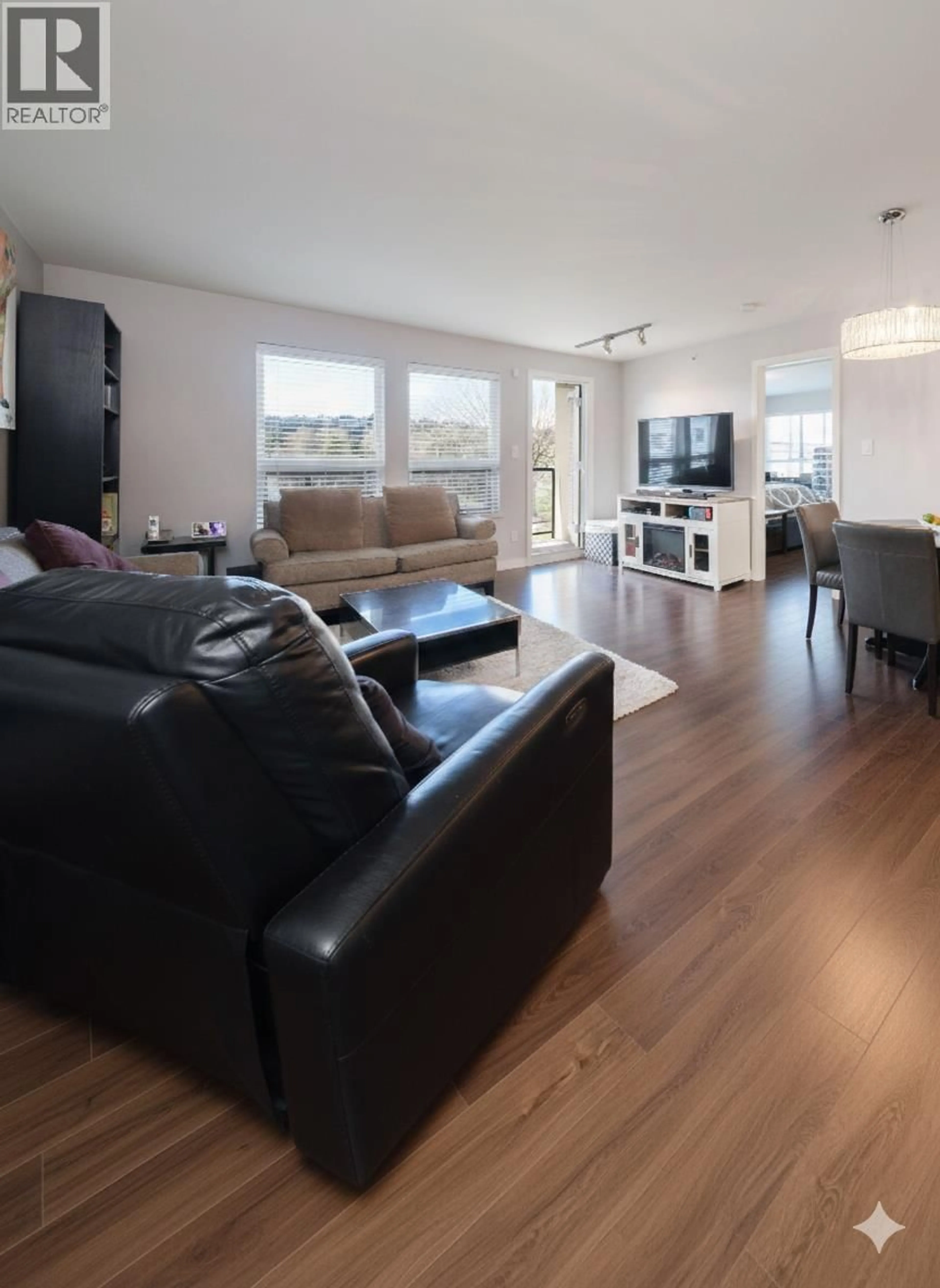 Living room with furniture, wood/laminate floor for 306 - 2191 SHAUGHNESSY STREET, Port Coquitlam British Columbia V3C3C7