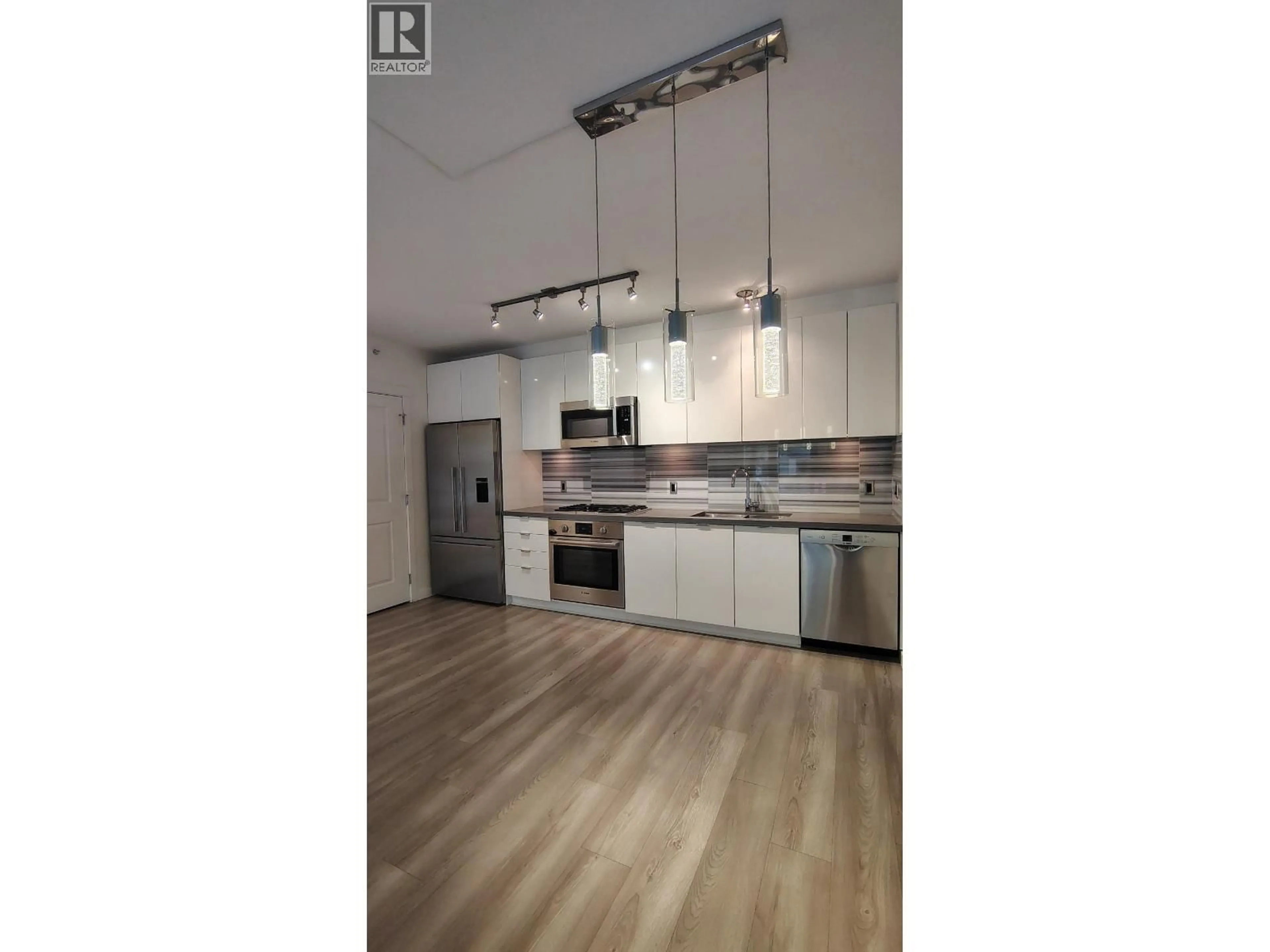 Open concept kitchen, wood/laminate floor for 101 - 3168 RIVERWALK AVENUE, Vancouver British Columbia V5S0B8