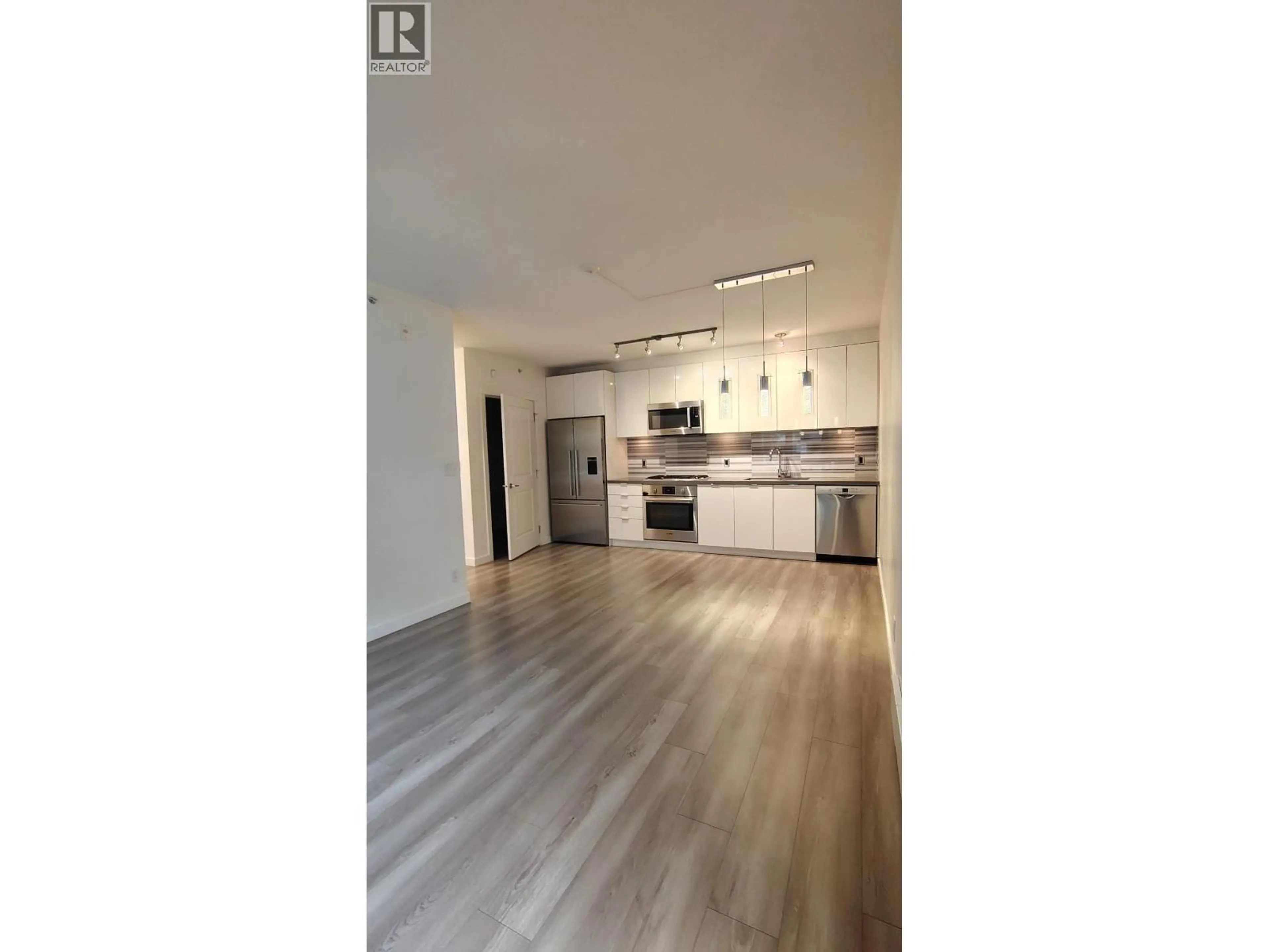 Open concept kitchen, wood/laminate floor for 101 - 3168 RIVERWALK AVENUE, Vancouver British Columbia V5S0B8