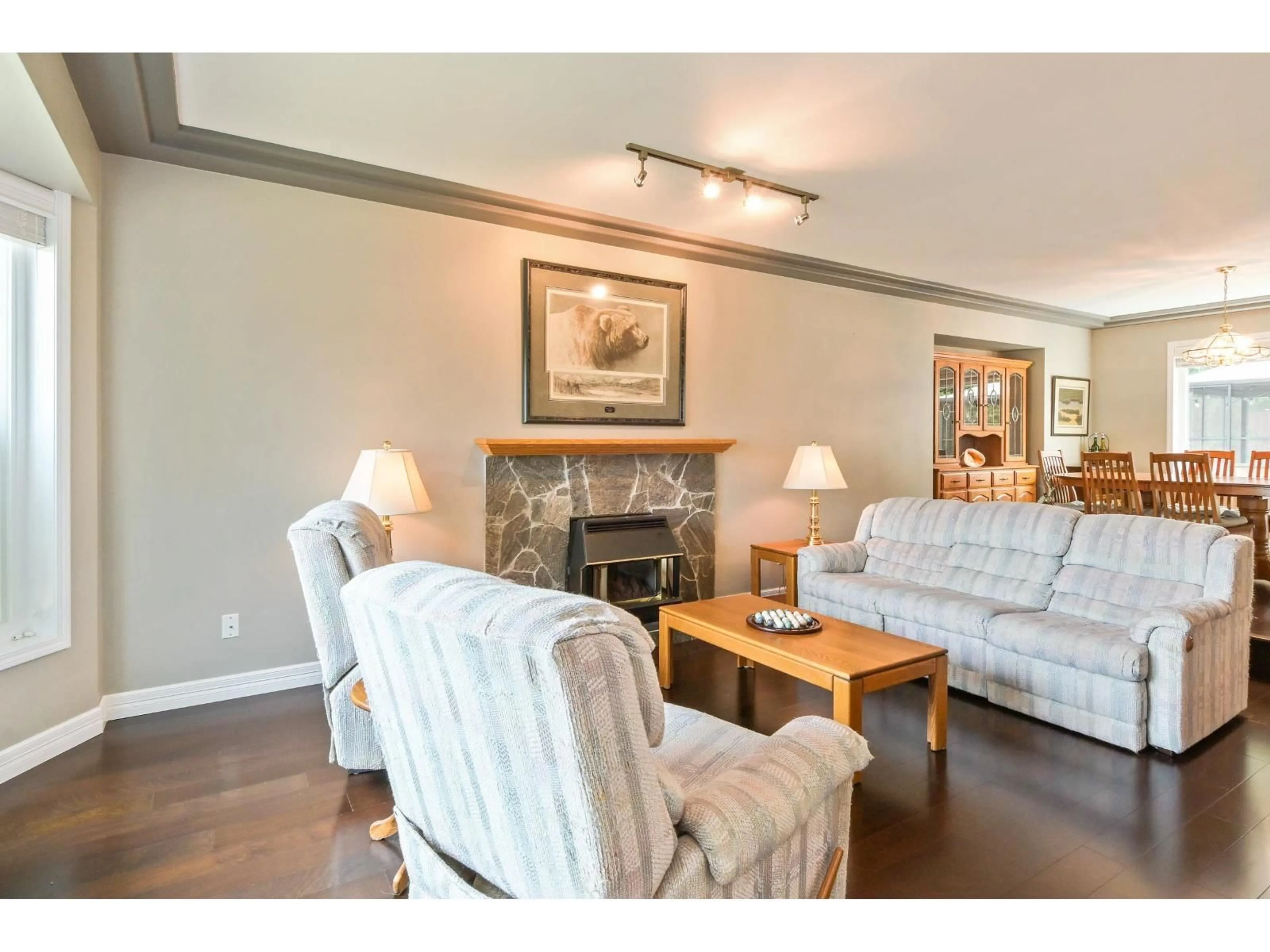 Living room with furniture, wood/laminate floor for 8415 214 STREET, Langley British Columbia V1M2J2