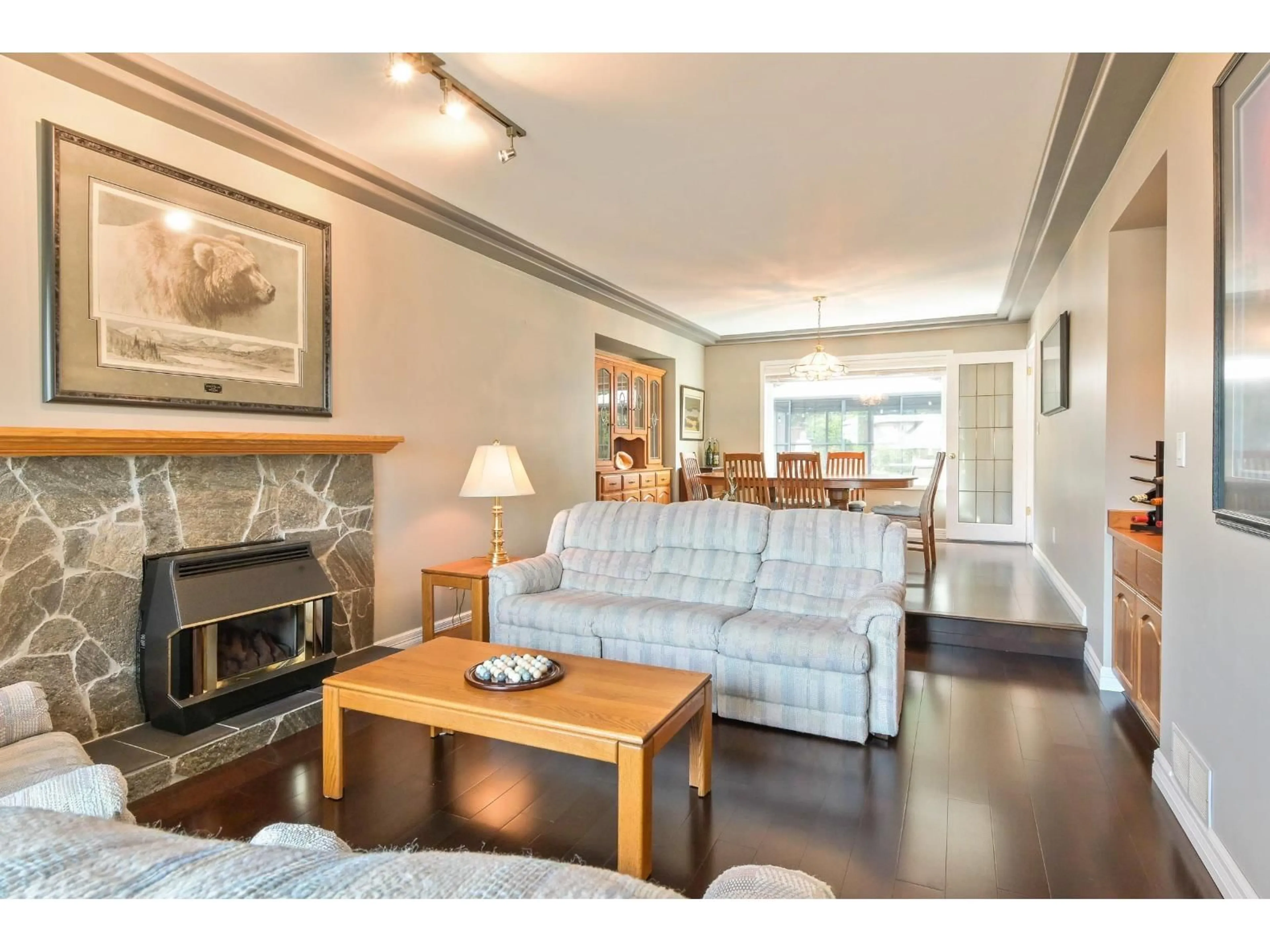 Living room with furniture, wood/laminate floor for 8415 214 STREET, Langley British Columbia V1M2J2