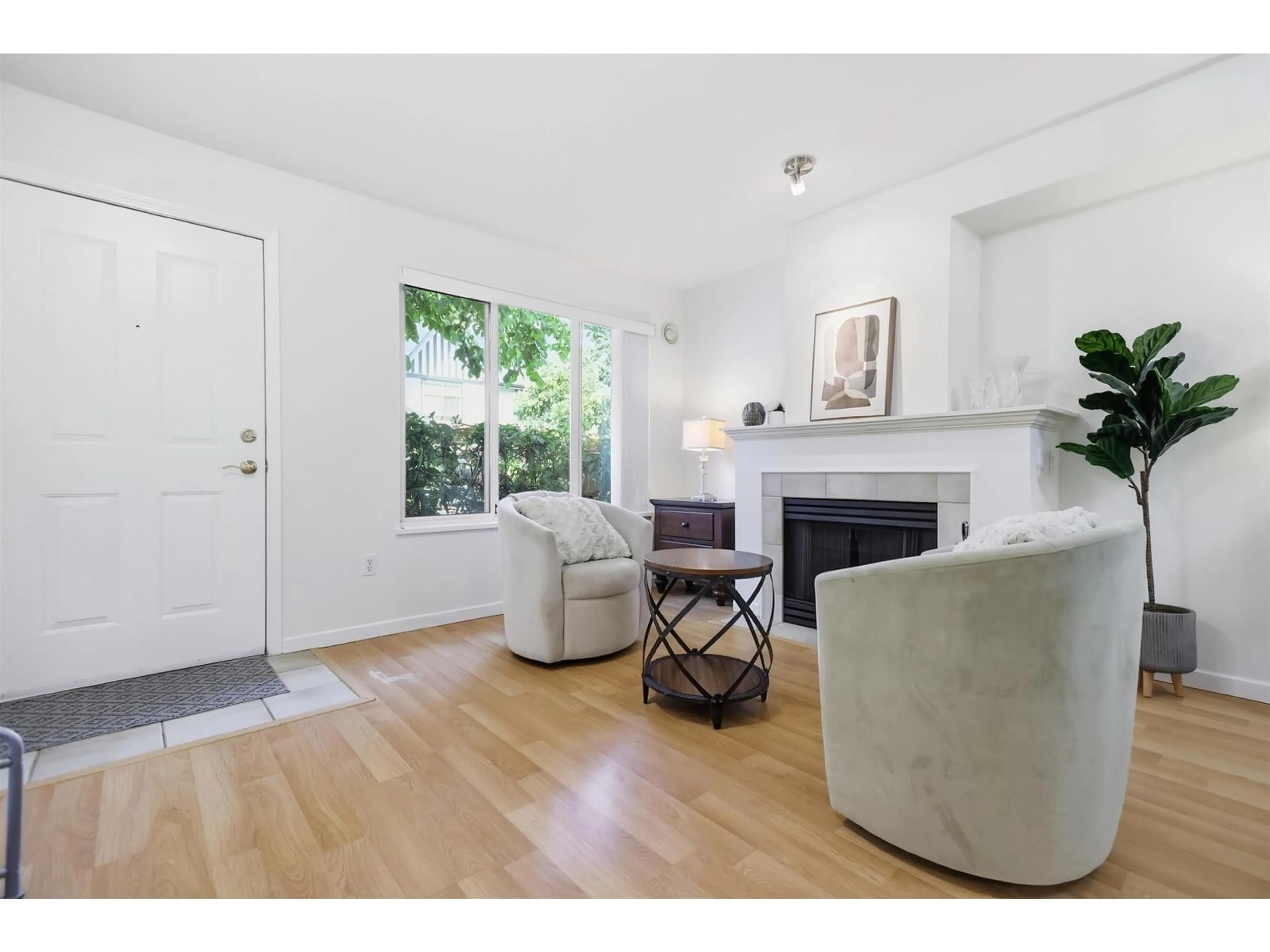 Living room with furniture, wood/laminate floor for 6 - 18883 65 AVENUE, Surrey British Columbia V3S8Y2
