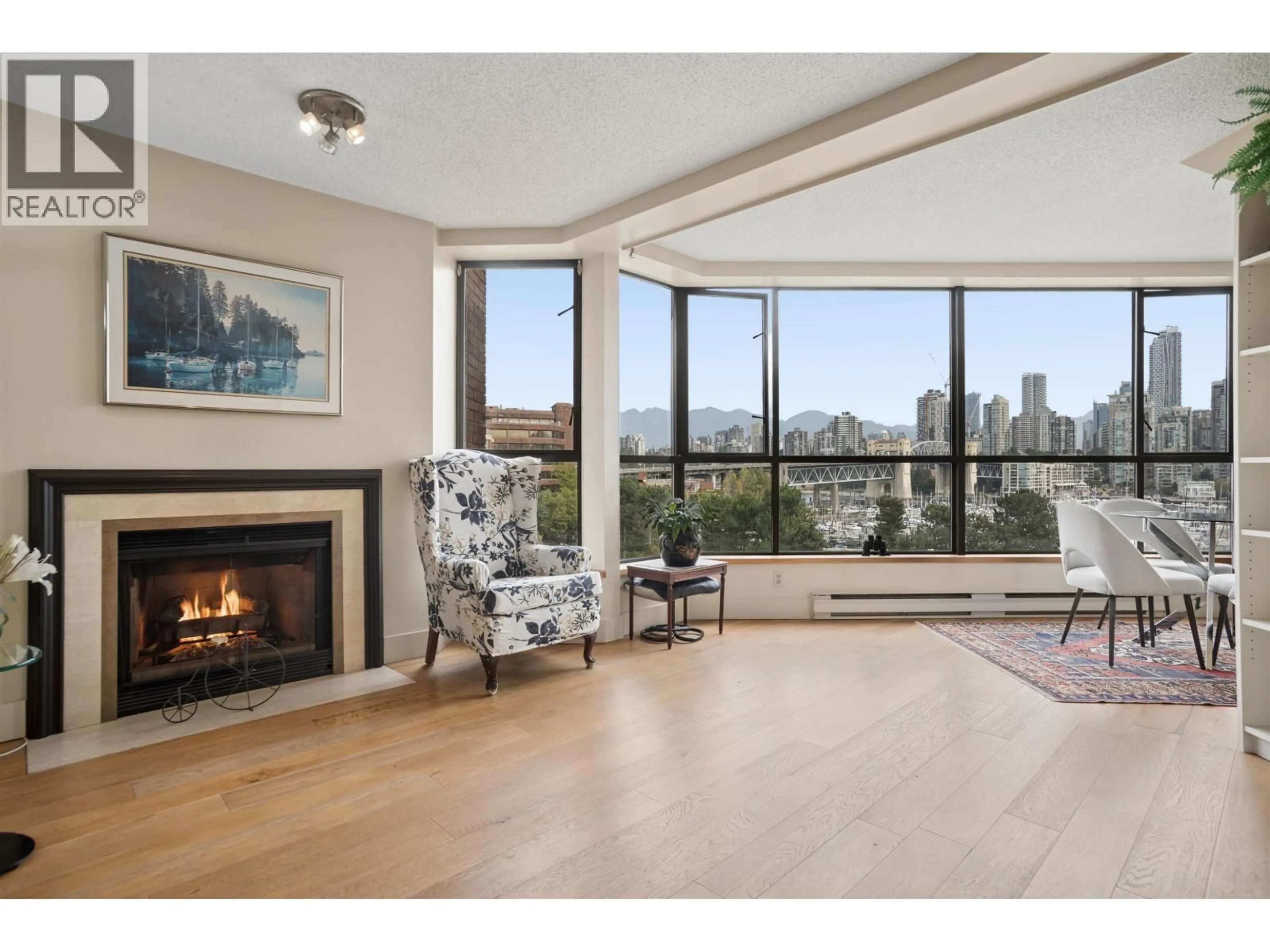 Living room with furniture, wood/laminate floor for 602 - 1490 PENNYFARTHING DRIVE, Vancouver British Columbia V6J4Z3