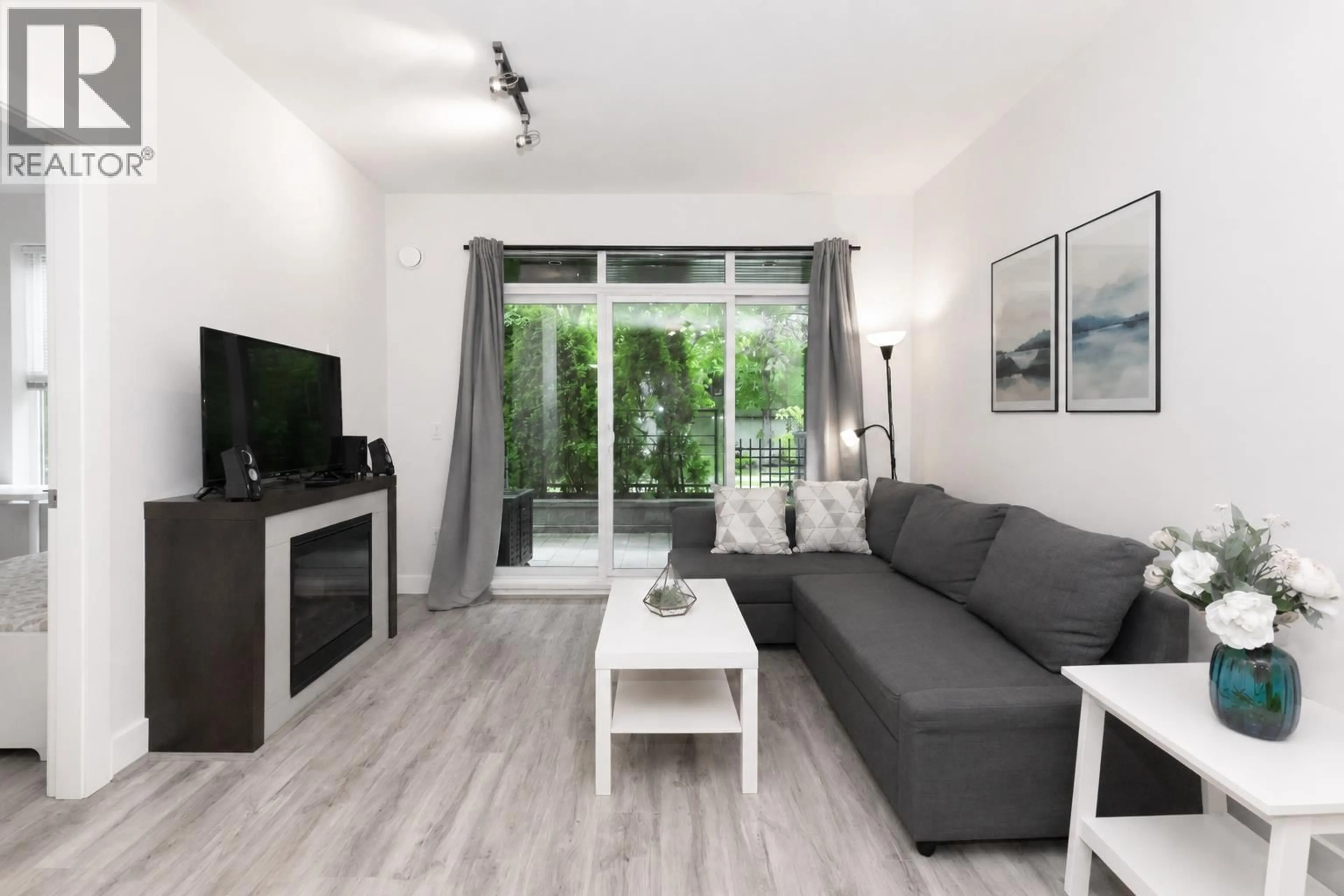 Living room with furniture, wood/laminate floor for 107 - 5928 BIRNEY AVENUE, Vancouver British Columbia V6S0B5