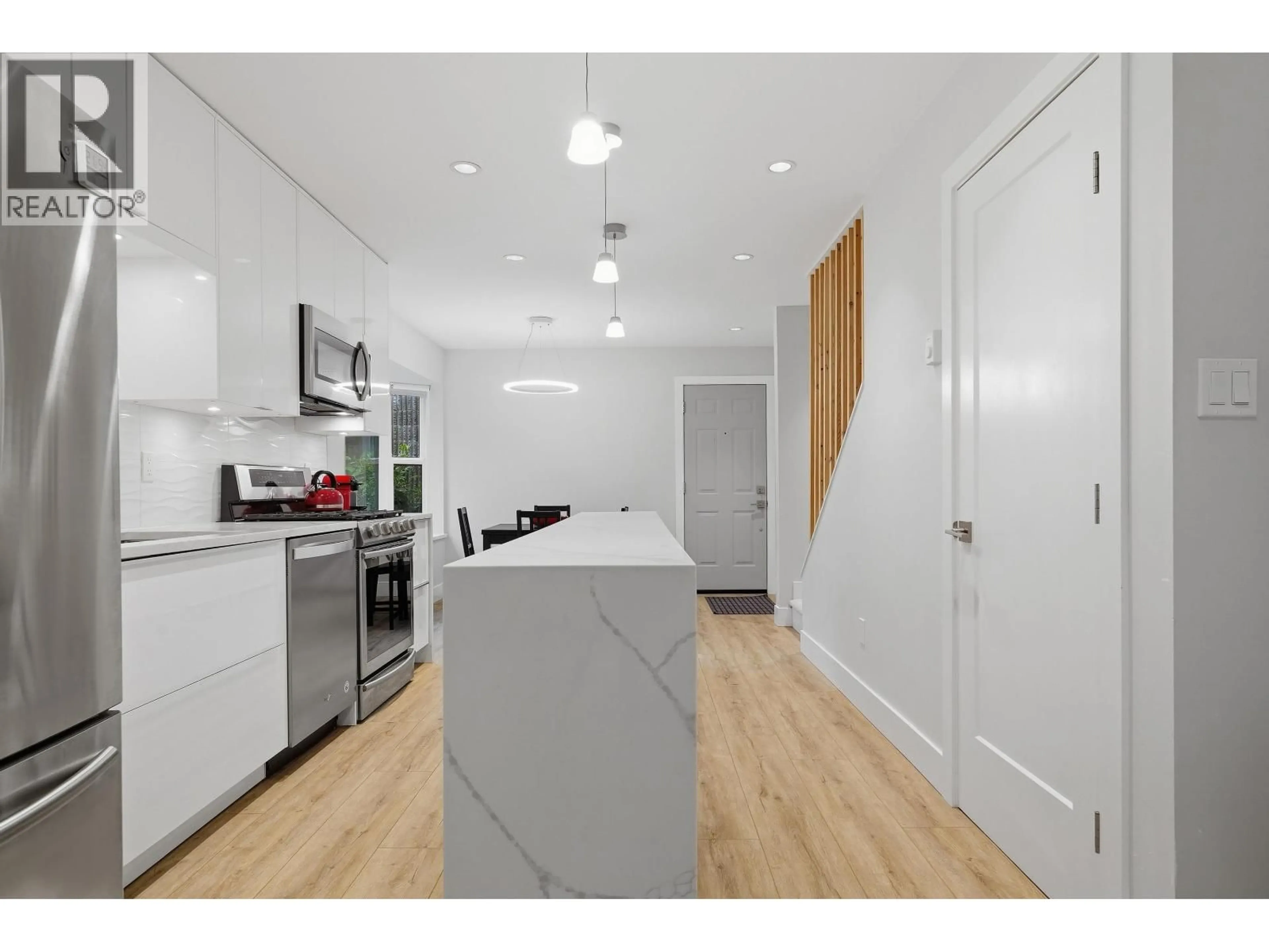 Open concept kitchen, wood/laminate floor for 4212 GARDEN GROVE DRIVE, Burnaby British Columbia V5G4G6
