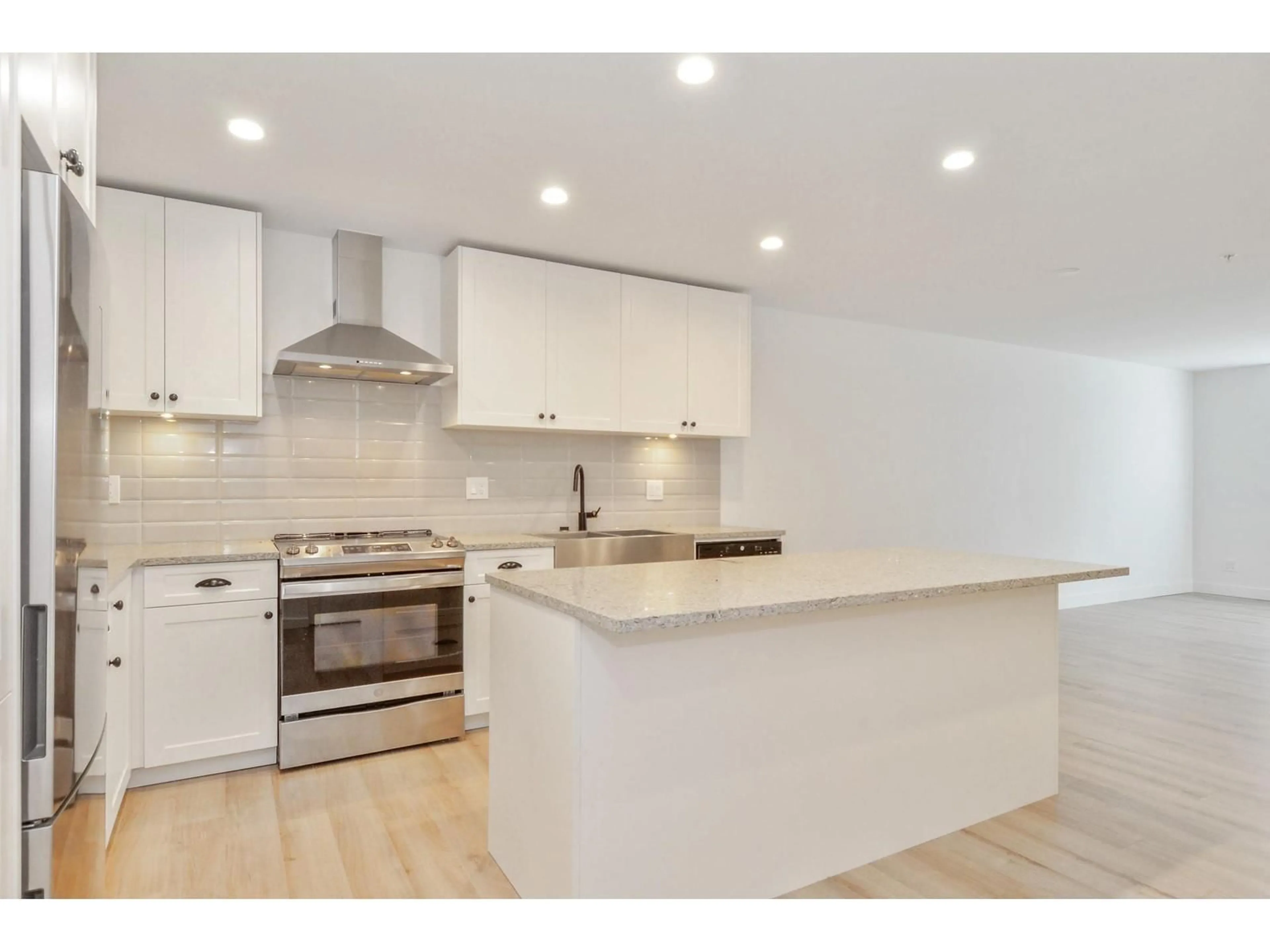 Open concept kitchen, wood/laminate floor for A108 - 20487 65 AVENUE, Langley British Columbia V2Y3K5