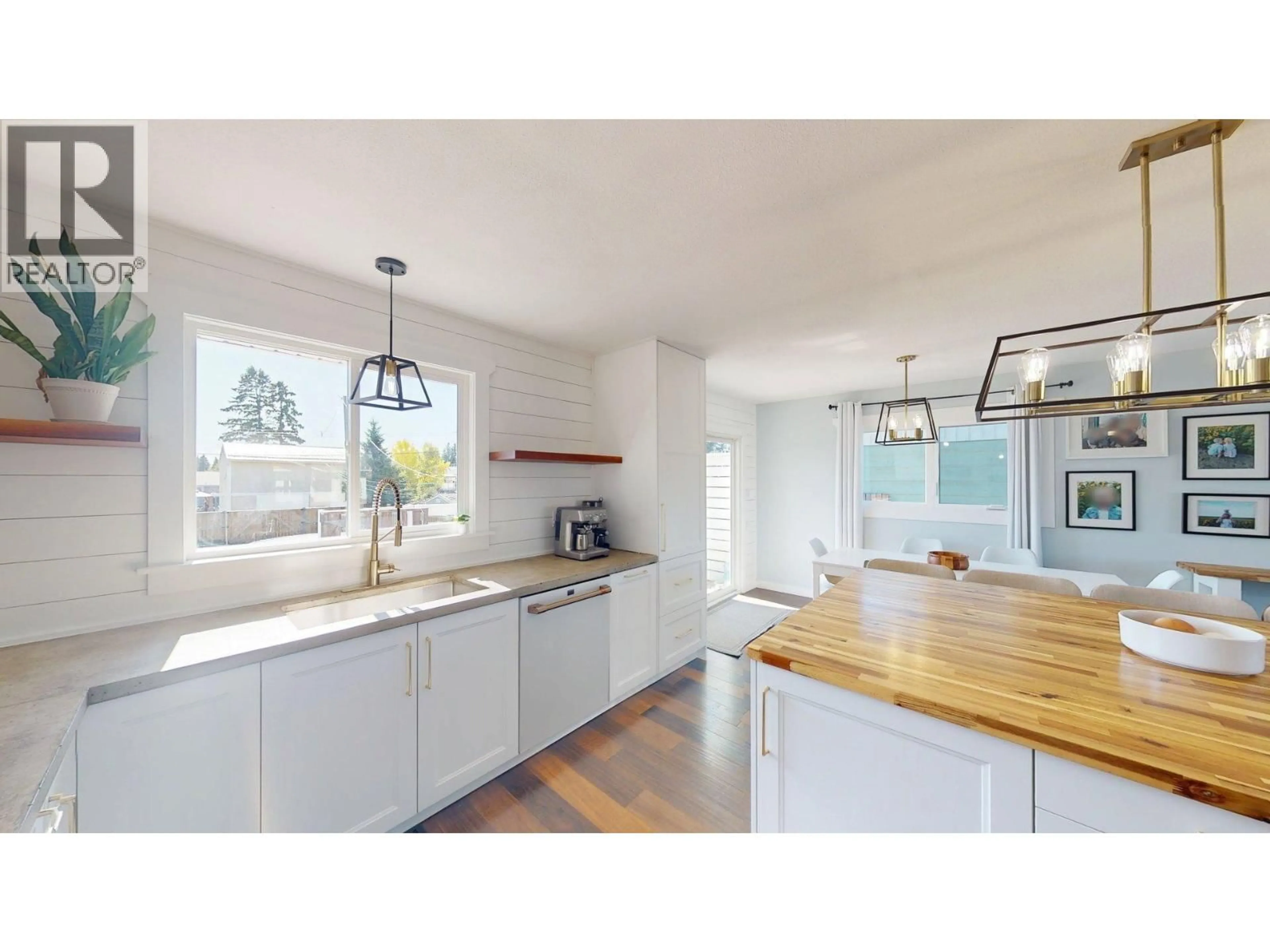 Open concept kitchen, wood/laminate floor for 8111 96 AVENUE, Fort St. John British Columbia V1J1J5