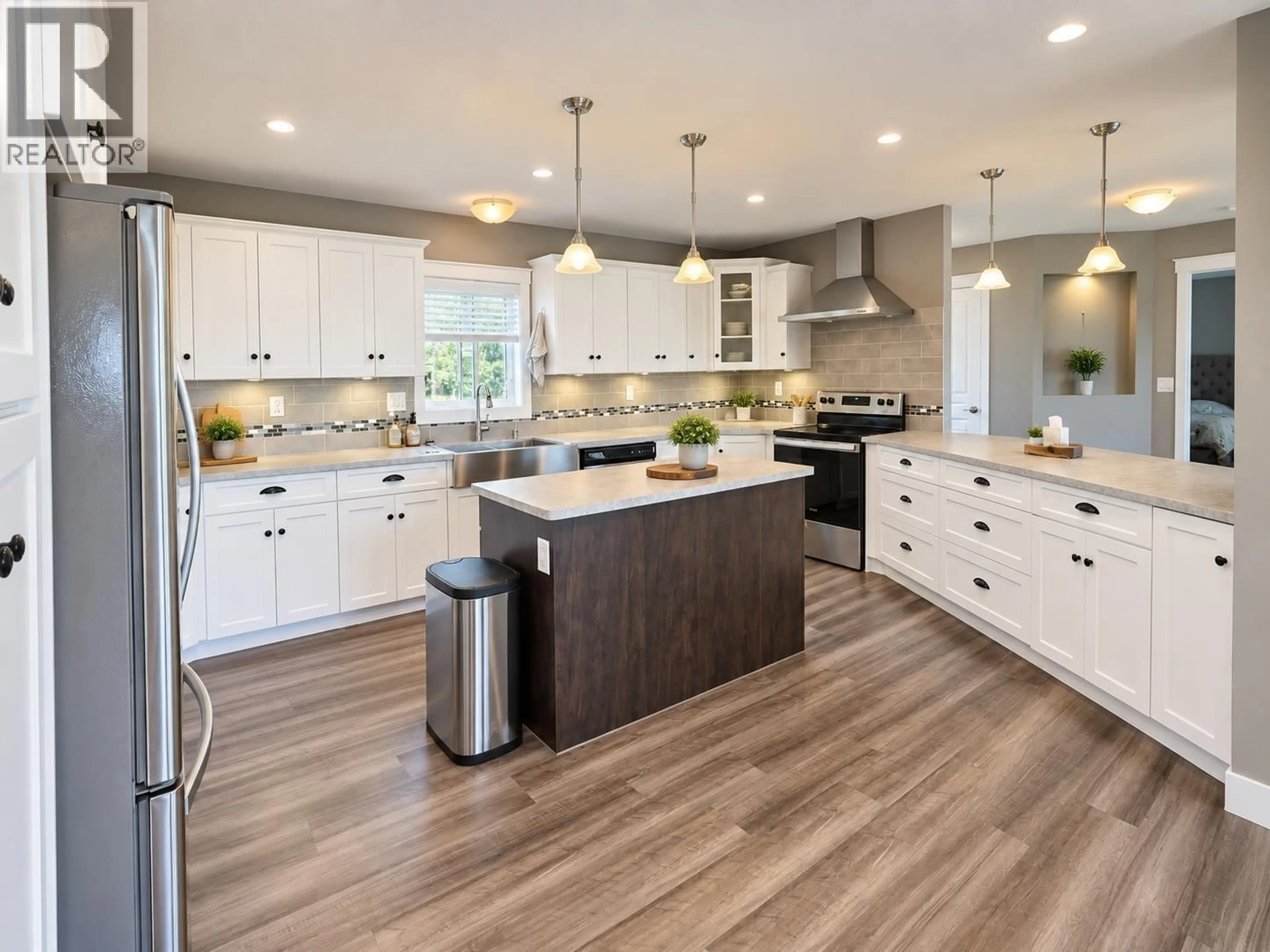 Open concept kitchen, wood/laminate floor for 4795 DAMMS ROAD, Prince George British Columbia V2N5X8