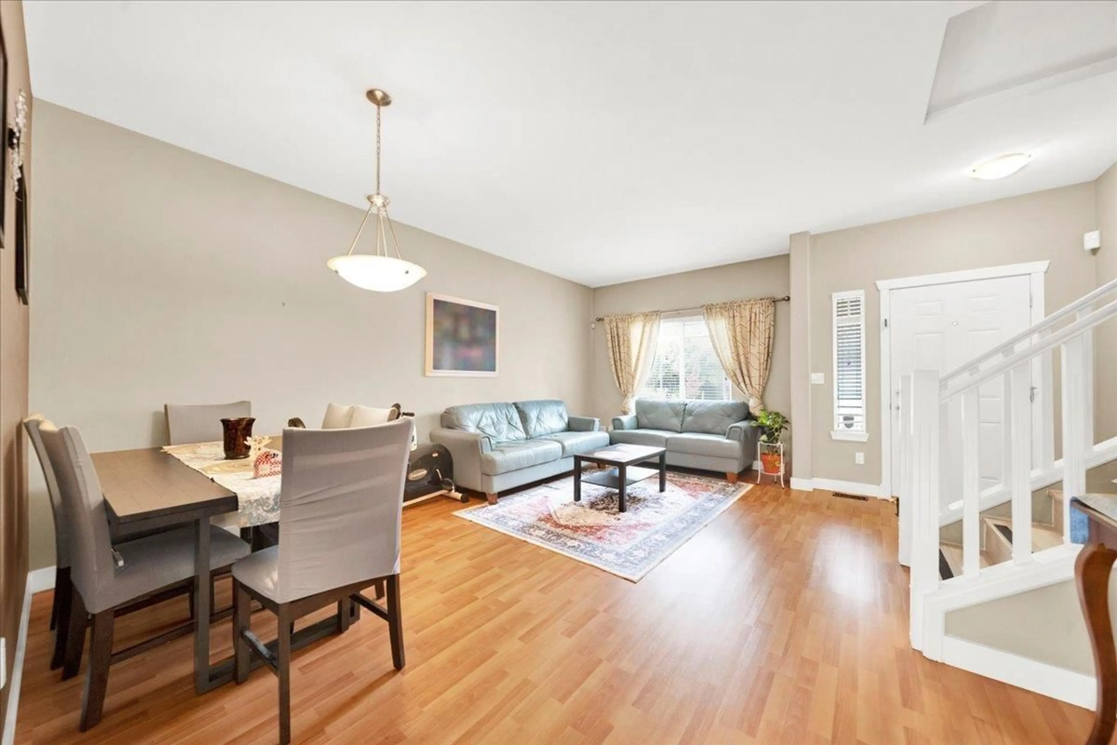 Living room with furniture, wood/laminate floor for 16628 60 AVENUE, Surrey British Columbia V3S1S9