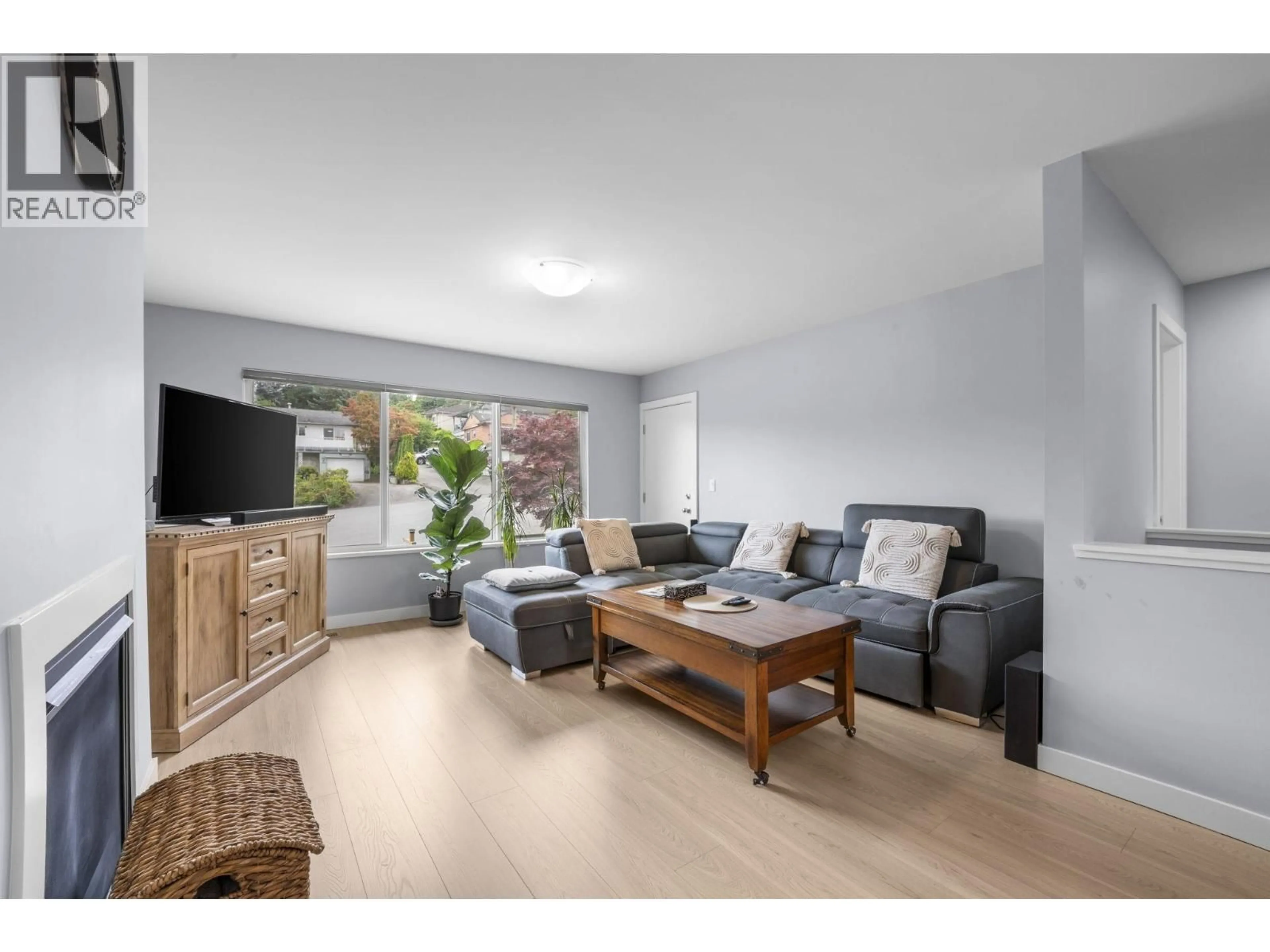 Living room with furniture, wood/laminate floor for 7737 ALLMAN STREET, Burnaby British Columbia V5E2A9