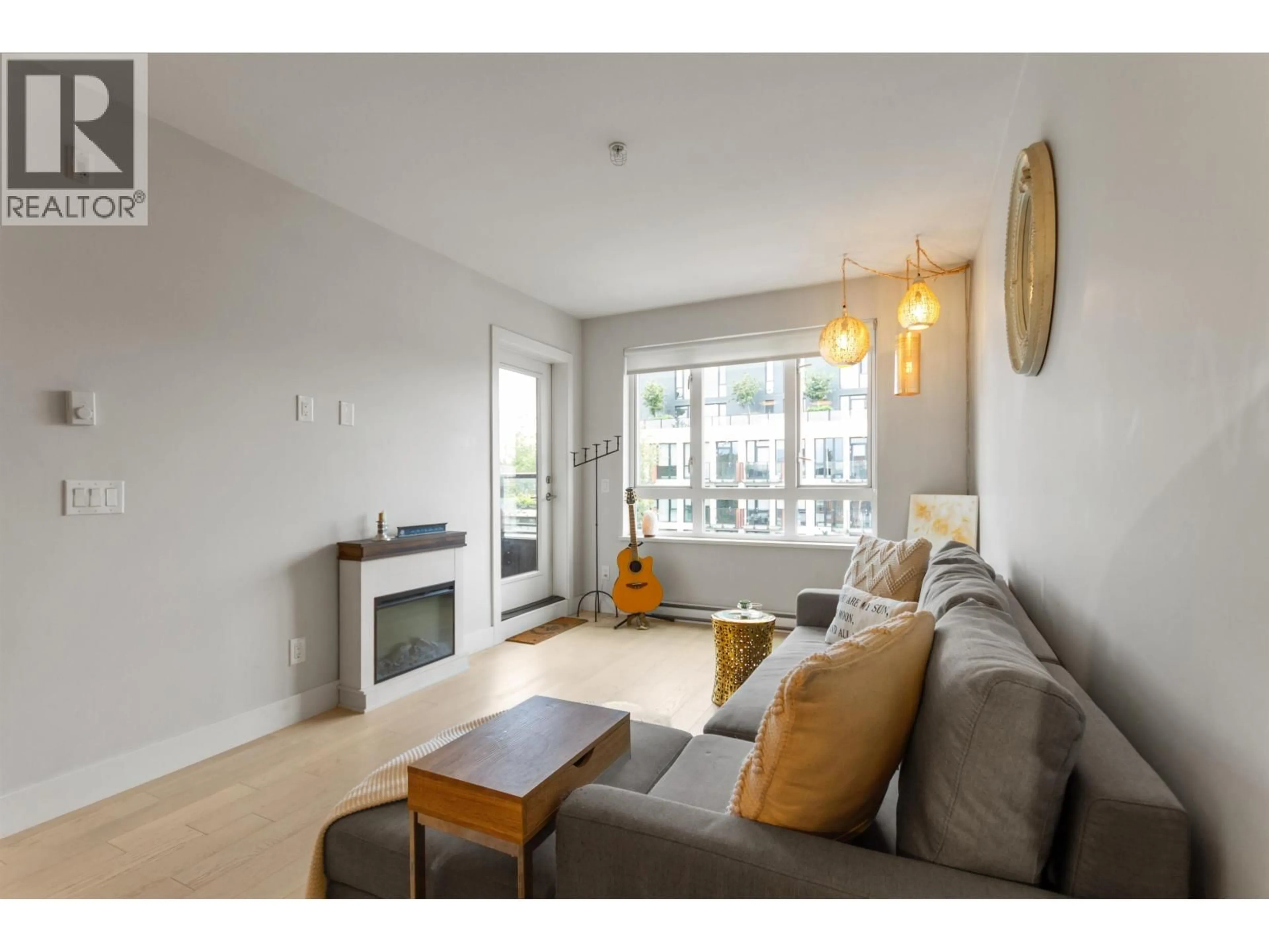 Living room with furniture, wood/laminate floor for 509 - 2477 CAROLINA STREET, Vancouver British Columbia V5T0G8