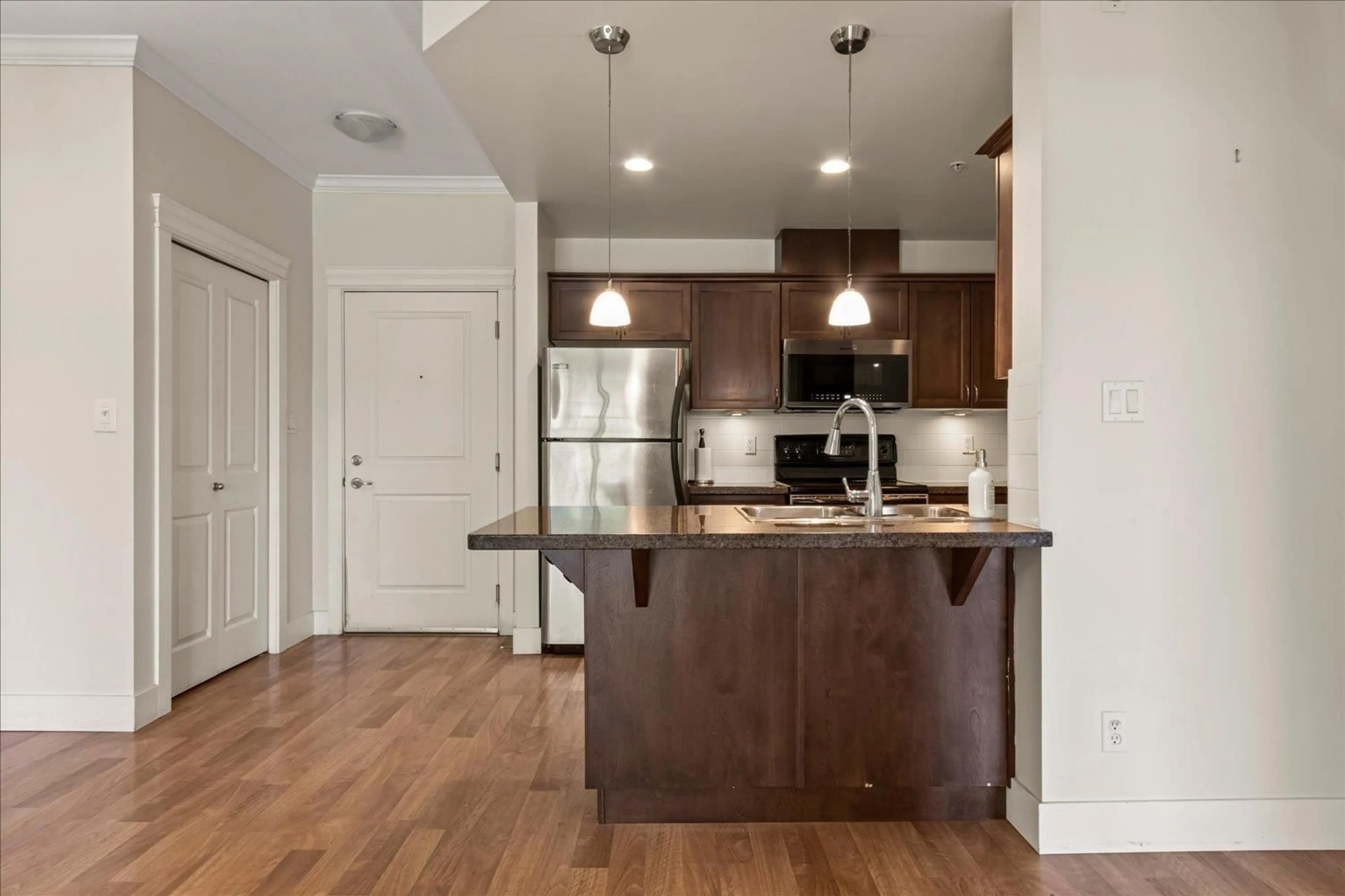 Open concept kitchen, wood/laminate floor for 302 - 33338 MAYFAIR AVENUE, Abbotsford British Columbia V2S0A4