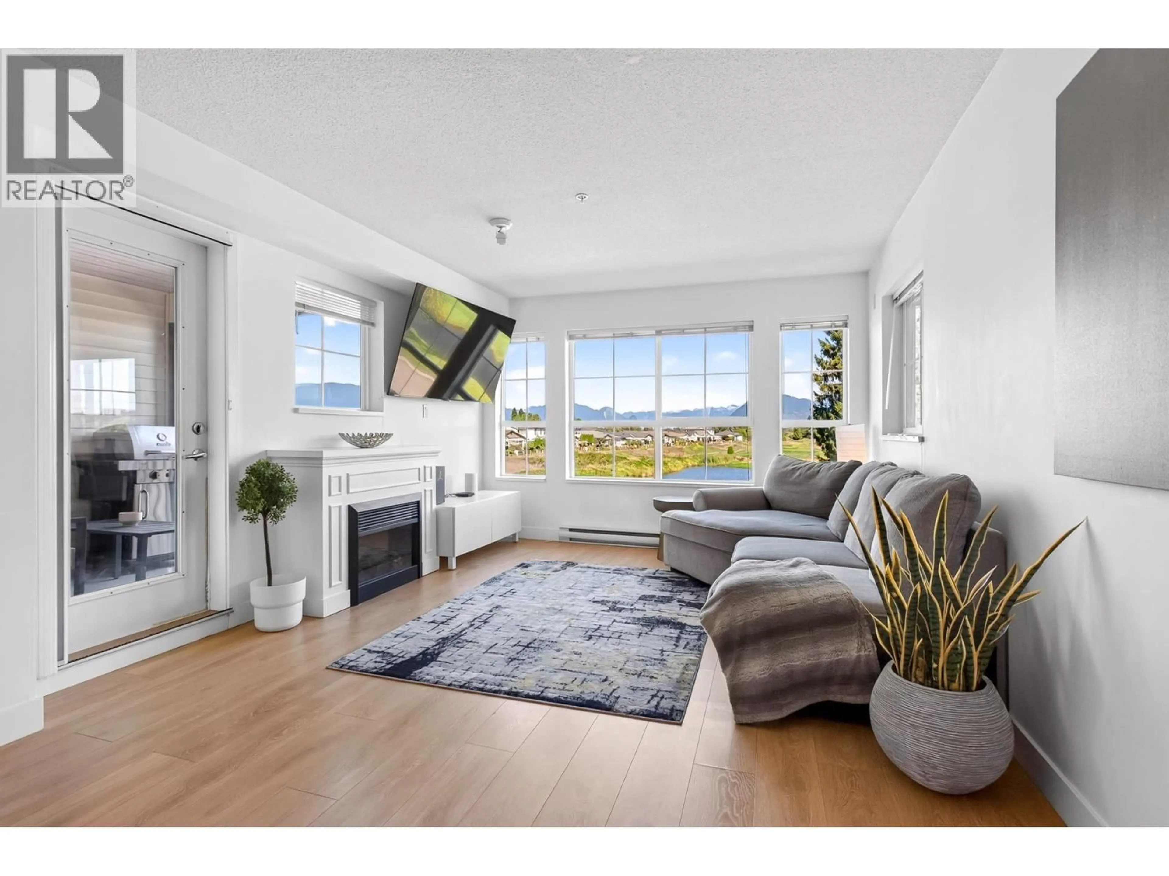 Living room with furniture, wood/laminate floor for 227 - 19673 MEADOW GARDENS WAY, Pitt Meadows British Columbia V3Y0A1