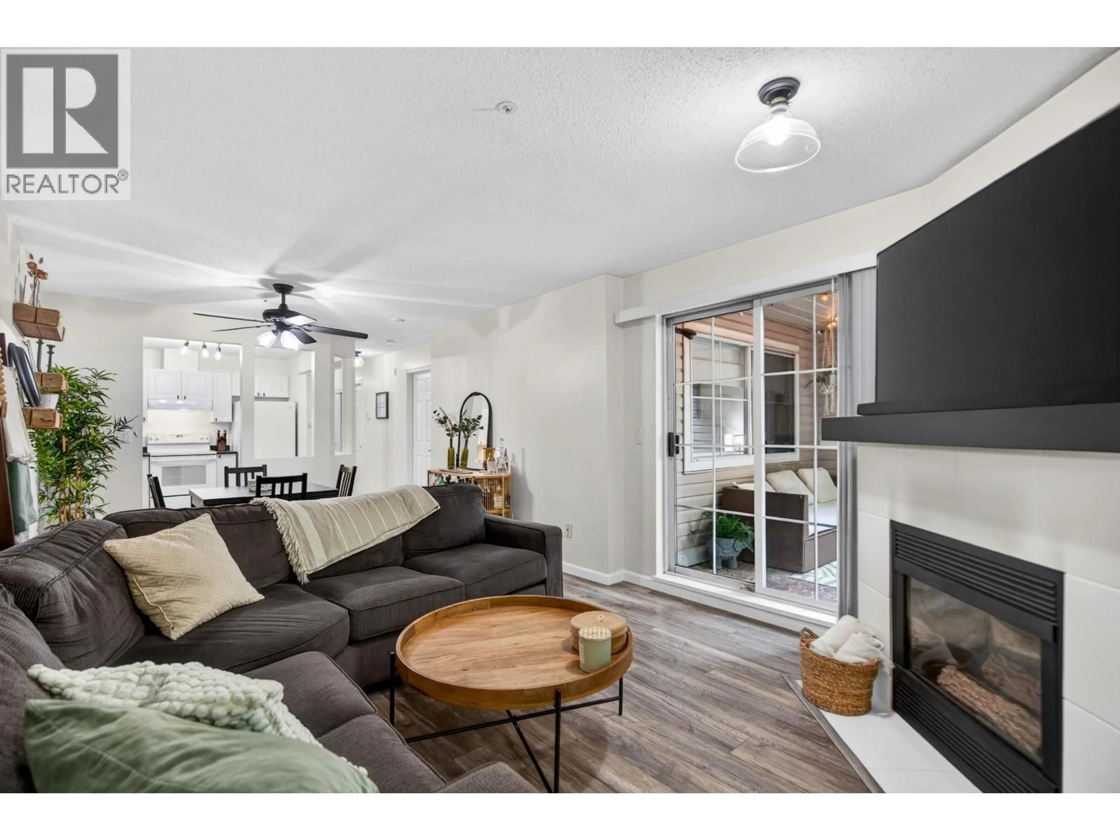 Living room with furniture, wood/laminate floor for 121 - 2678 DIXON STREET, Port Coquitlam British Columbia V3C6L7