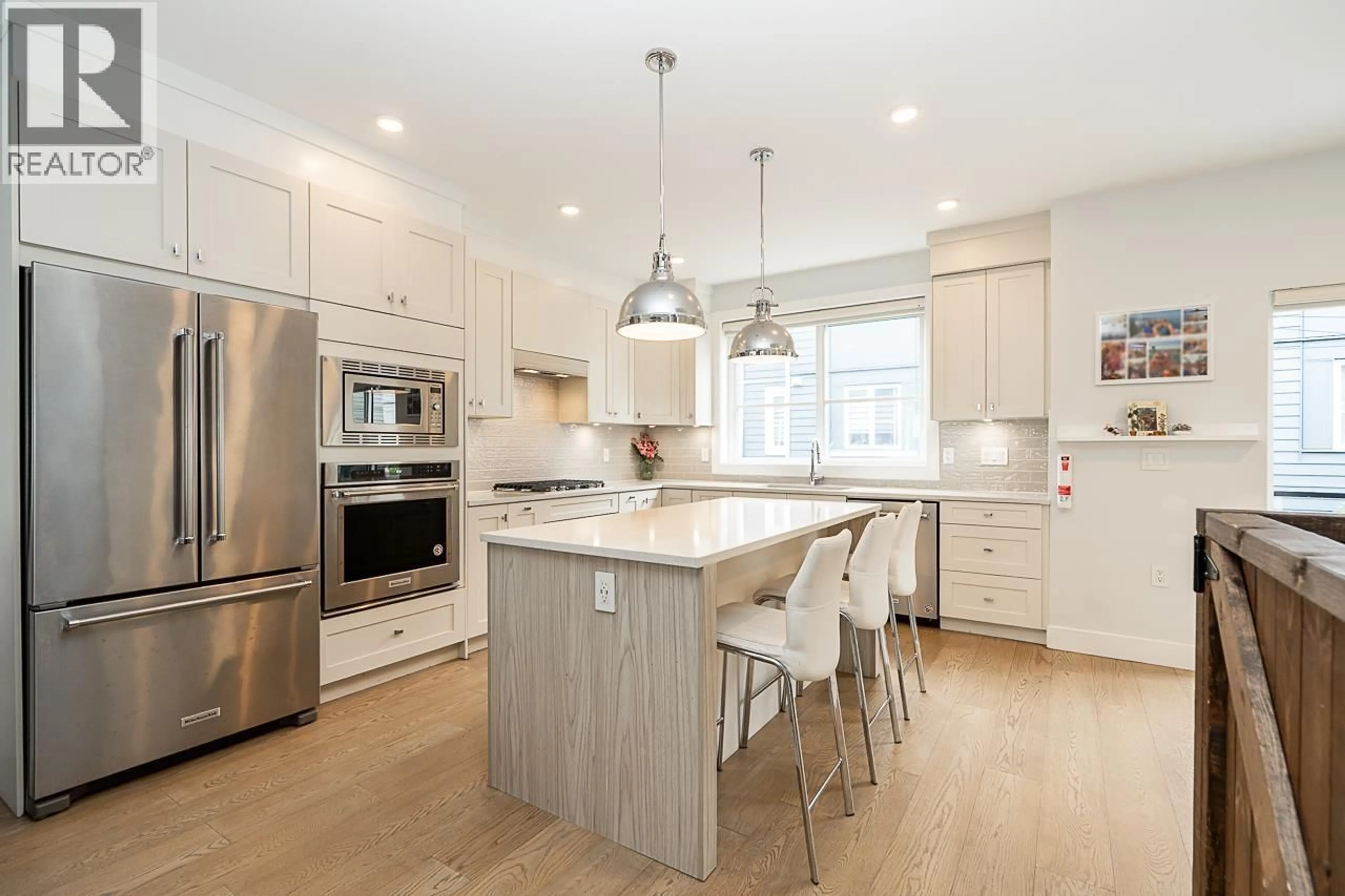 Open concept kitchen, wood/laminate floor for 26 - 5377 8A AVENUE, Delta British Columbia V4M0E2