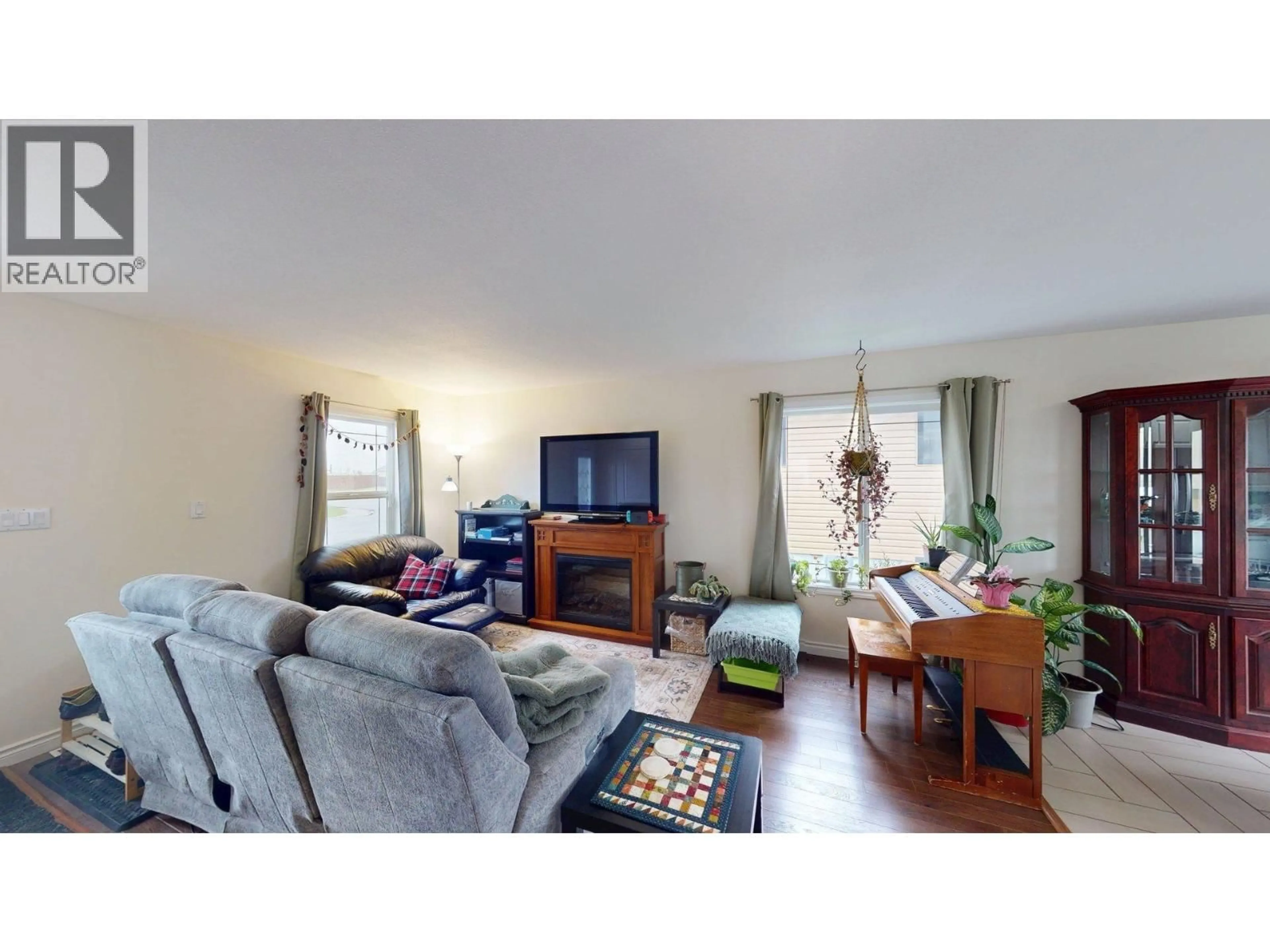 Living room with furniture, wood/laminate floor for 11328 86A STREET, Fort St. John British Columbia V1J0G2