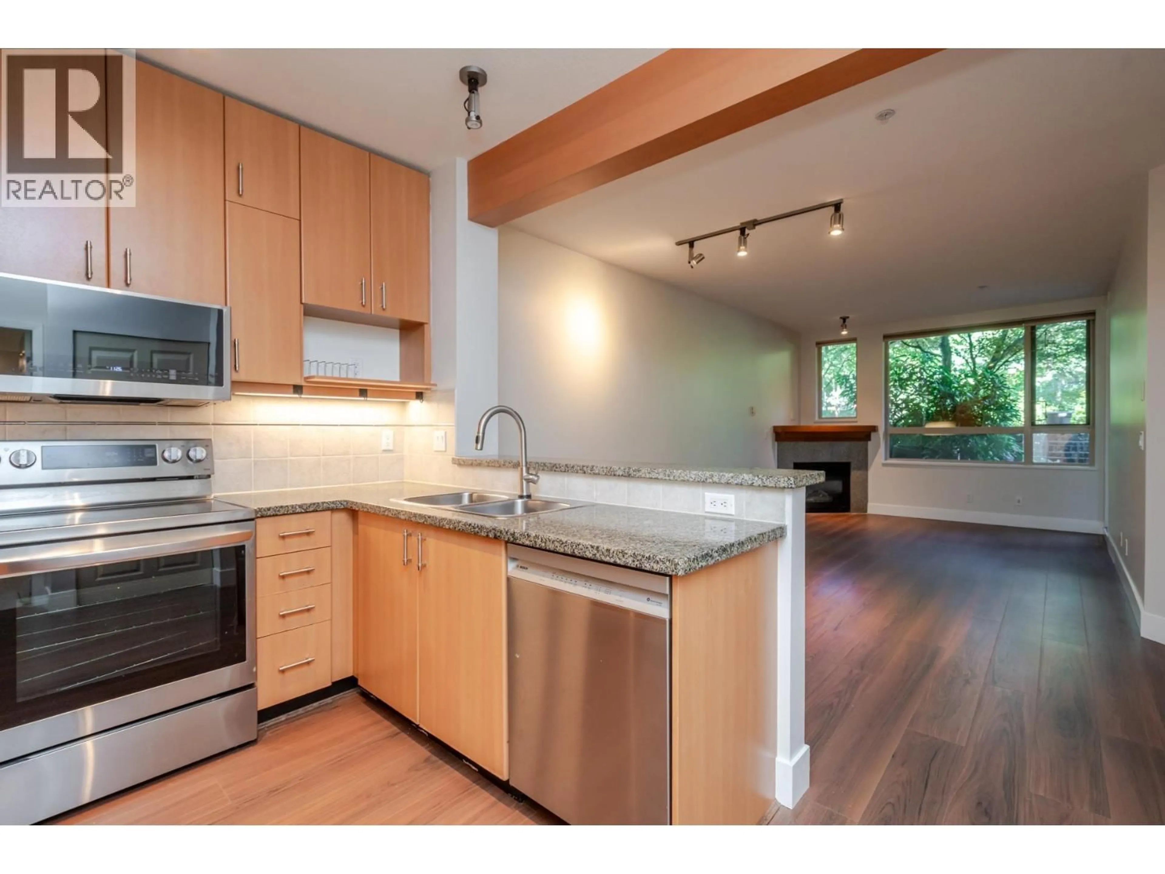 Open concept kitchen, wood/laminate floor for 204 - 580 RAVEN WOODS DRIVE, North Vancouver British Columbia V7G2T2