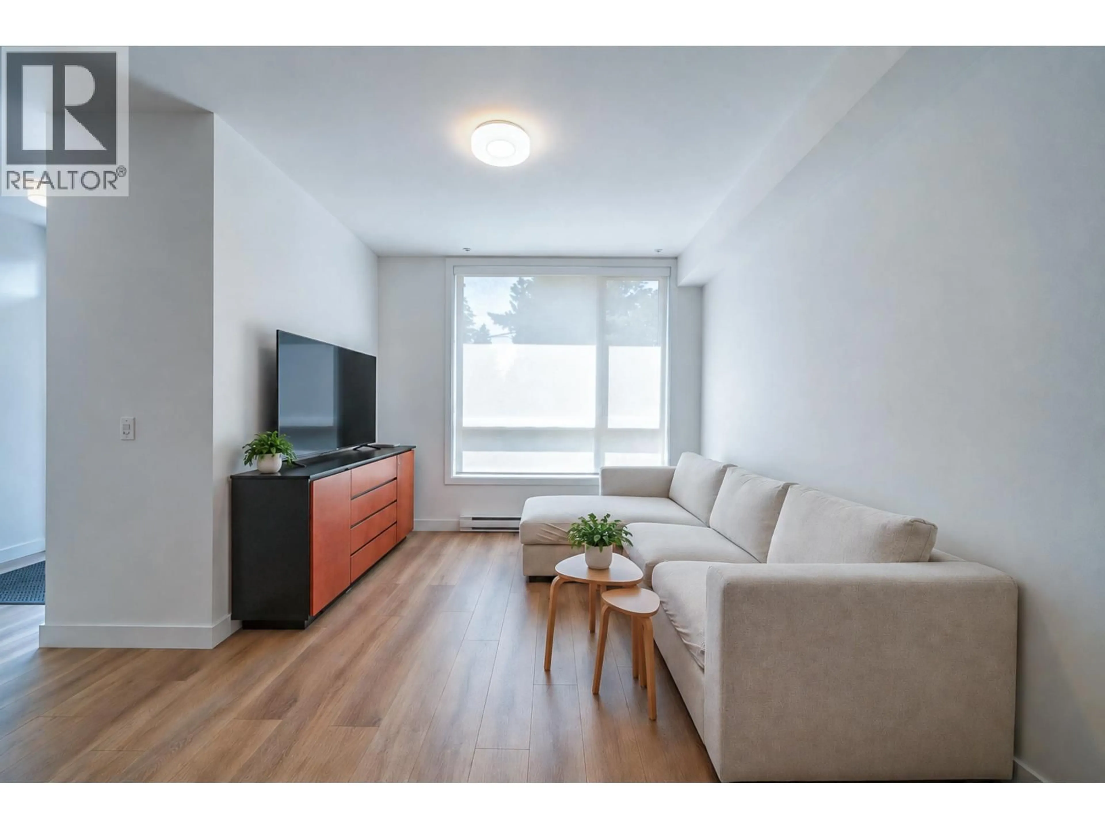 Living room with furniture, wood/laminate floor for 302 - 6085 IRMIN STREET, Burnaby British Columbia V5J5C5