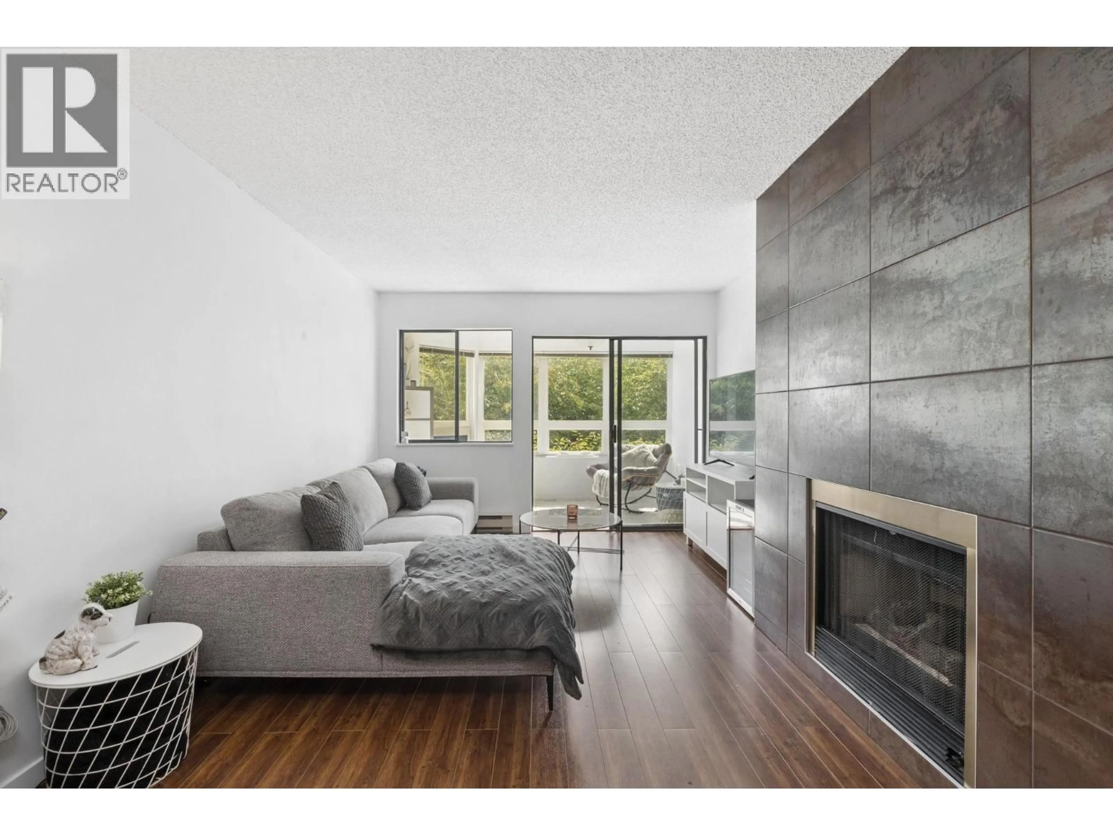 Living room with furniture, wood/laminate floor for 204 - 1155 ROSS RD, North Vancouver British Columbia V7K1C6