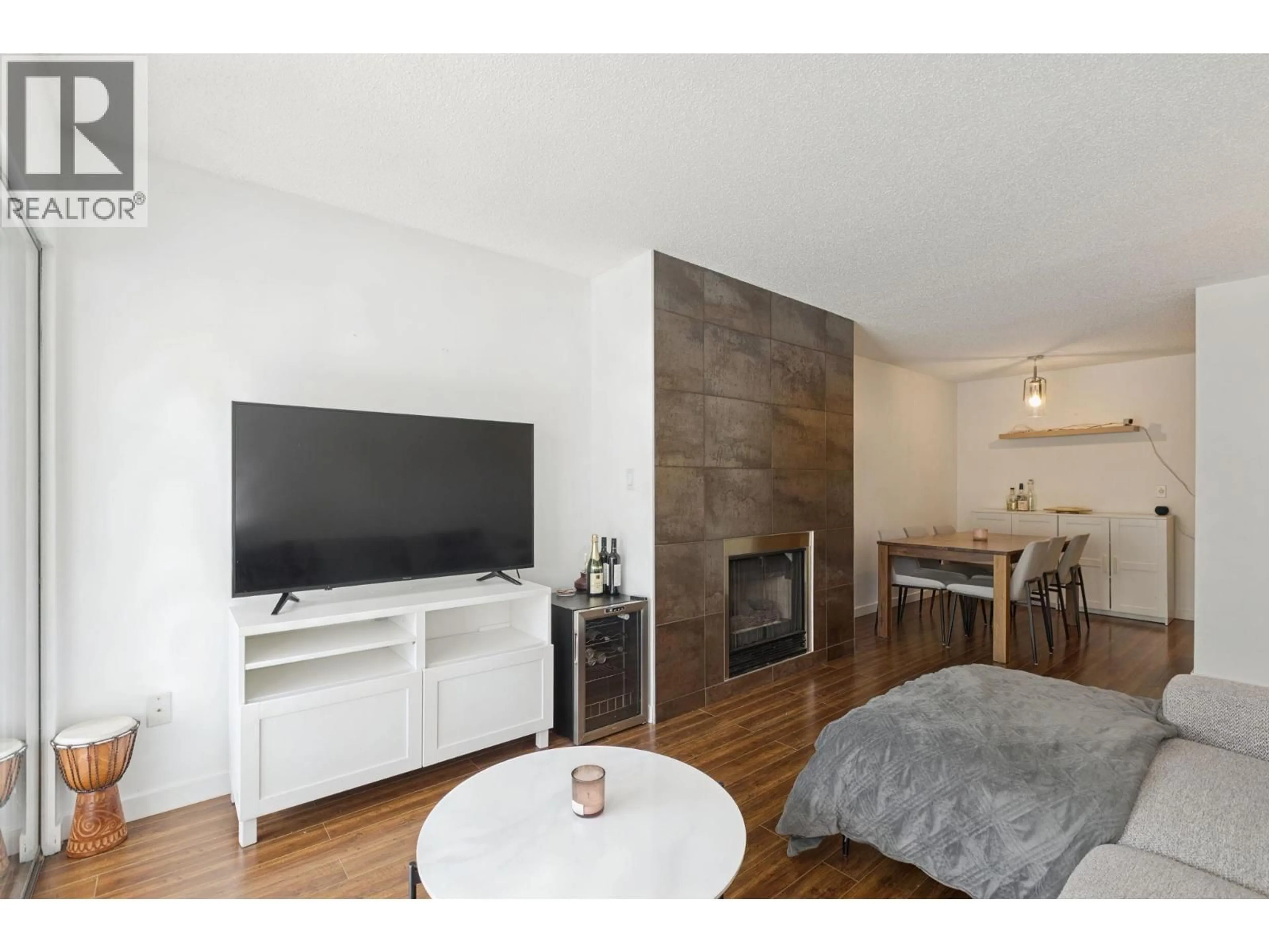 Living room with furniture, wood/laminate floor for 204 - 1155 ROSS RD, North Vancouver British Columbia V7K1C6