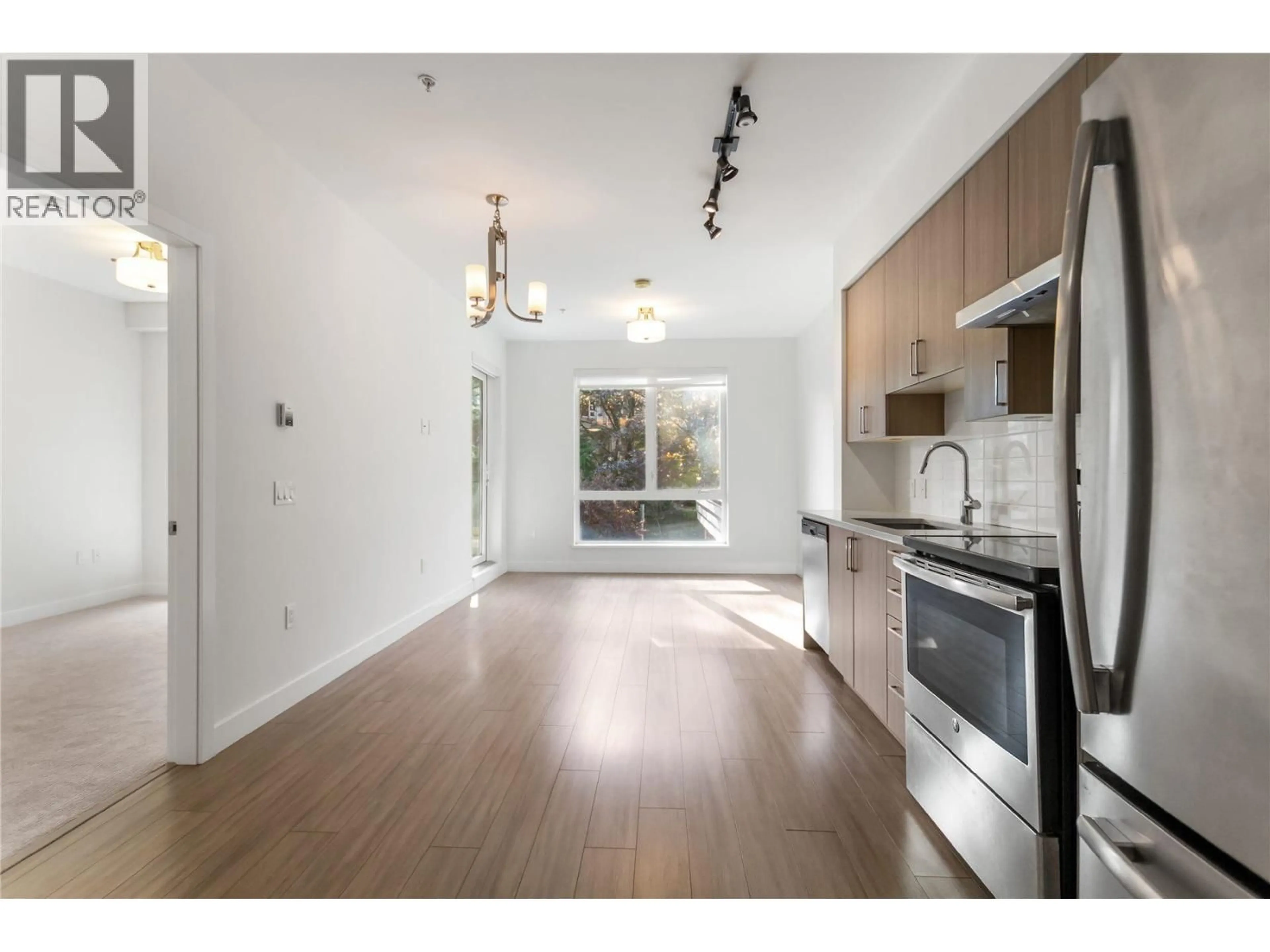 Open concept kitchen, wood/laminate floor for 206 - 3365 4TH AVENUE, Vancouver British Columbia V5M1L7