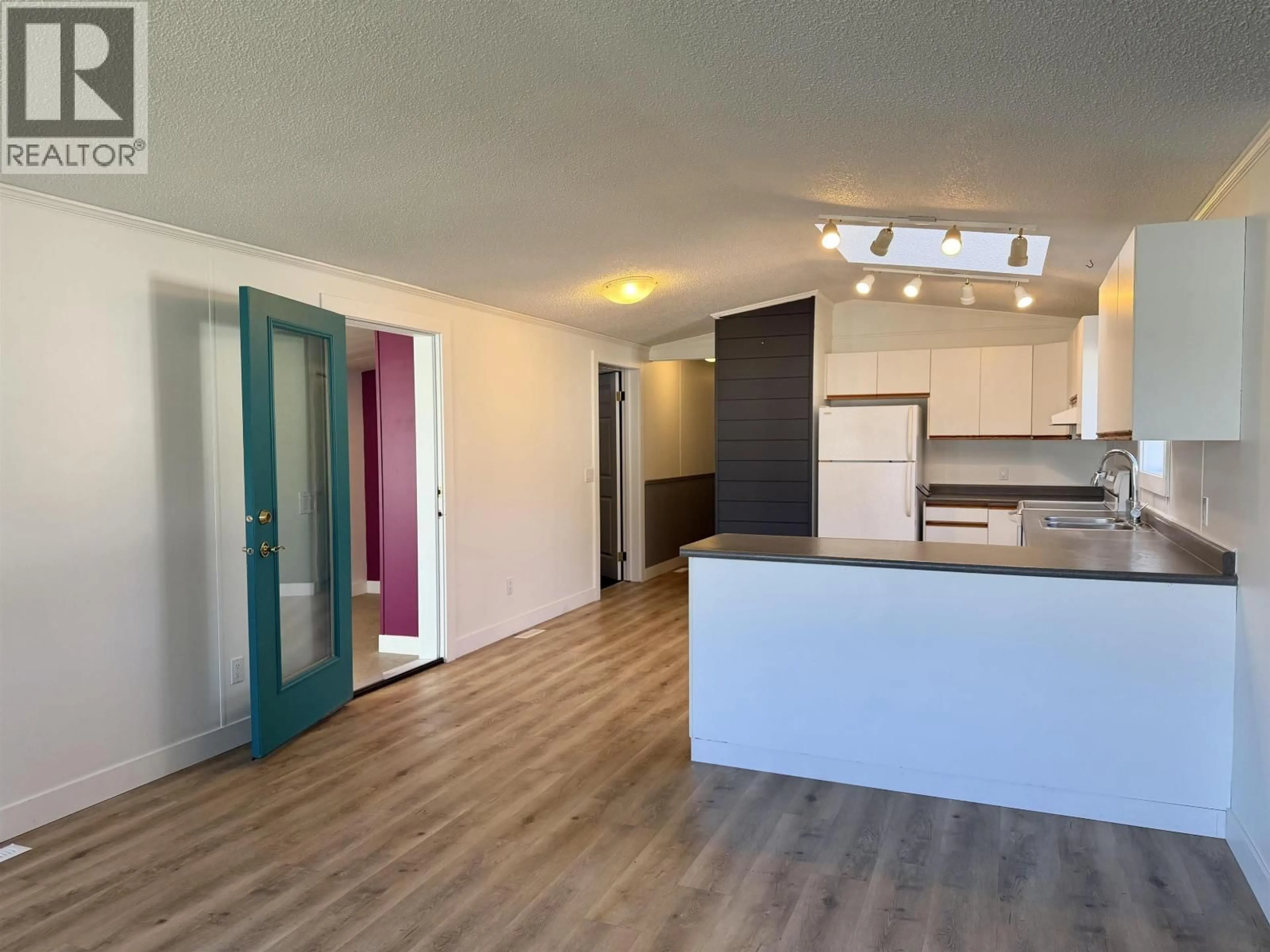 Open concept kitchen, wood/laminate floor for 3 - 3278 THIRD AVENUE, Smithers British Columbia V0J2N0