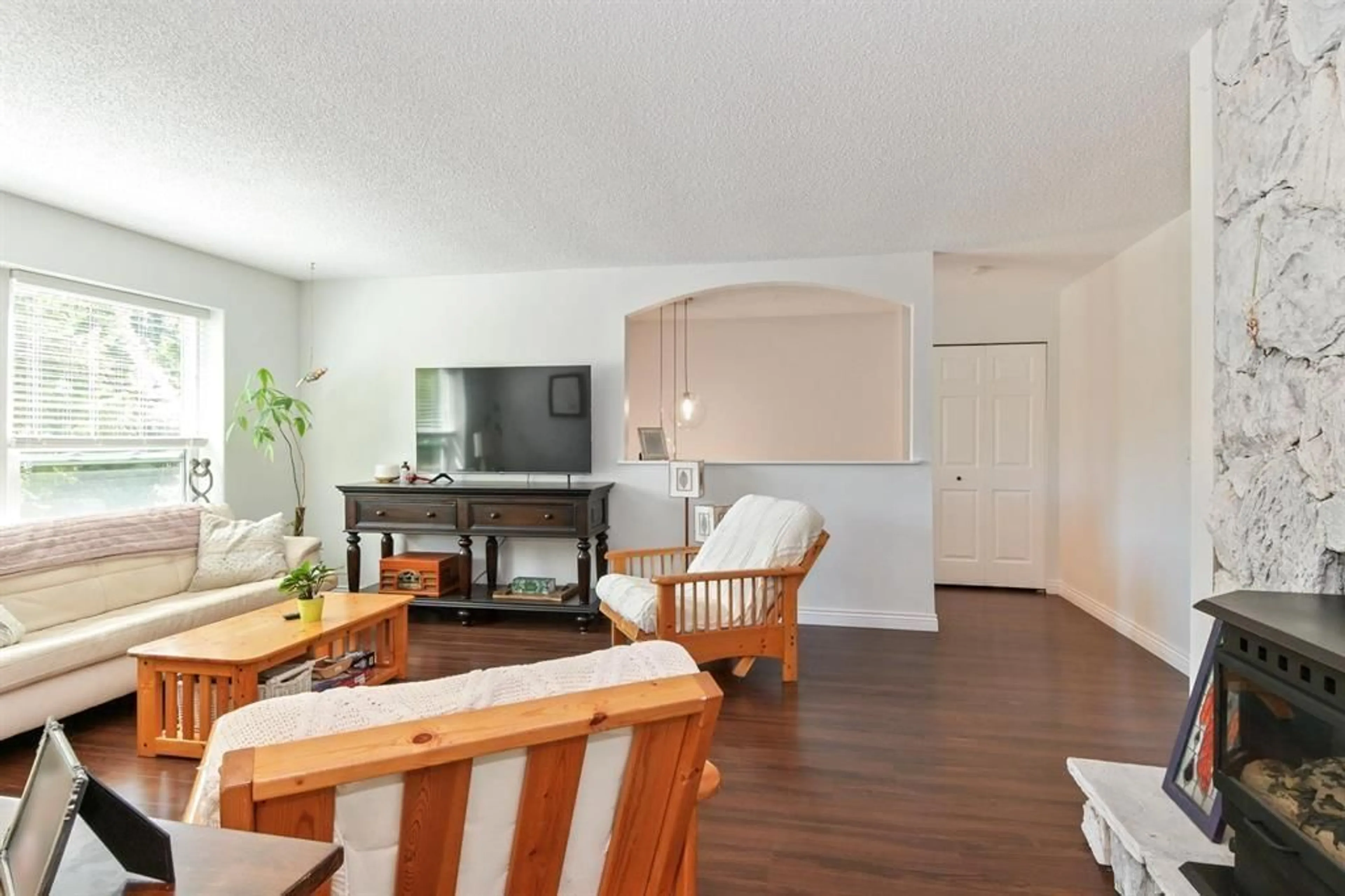 Living room with furniture, wood/laminate floor for 19919 51 AVENUE, Langley British Columbia V3A7P2