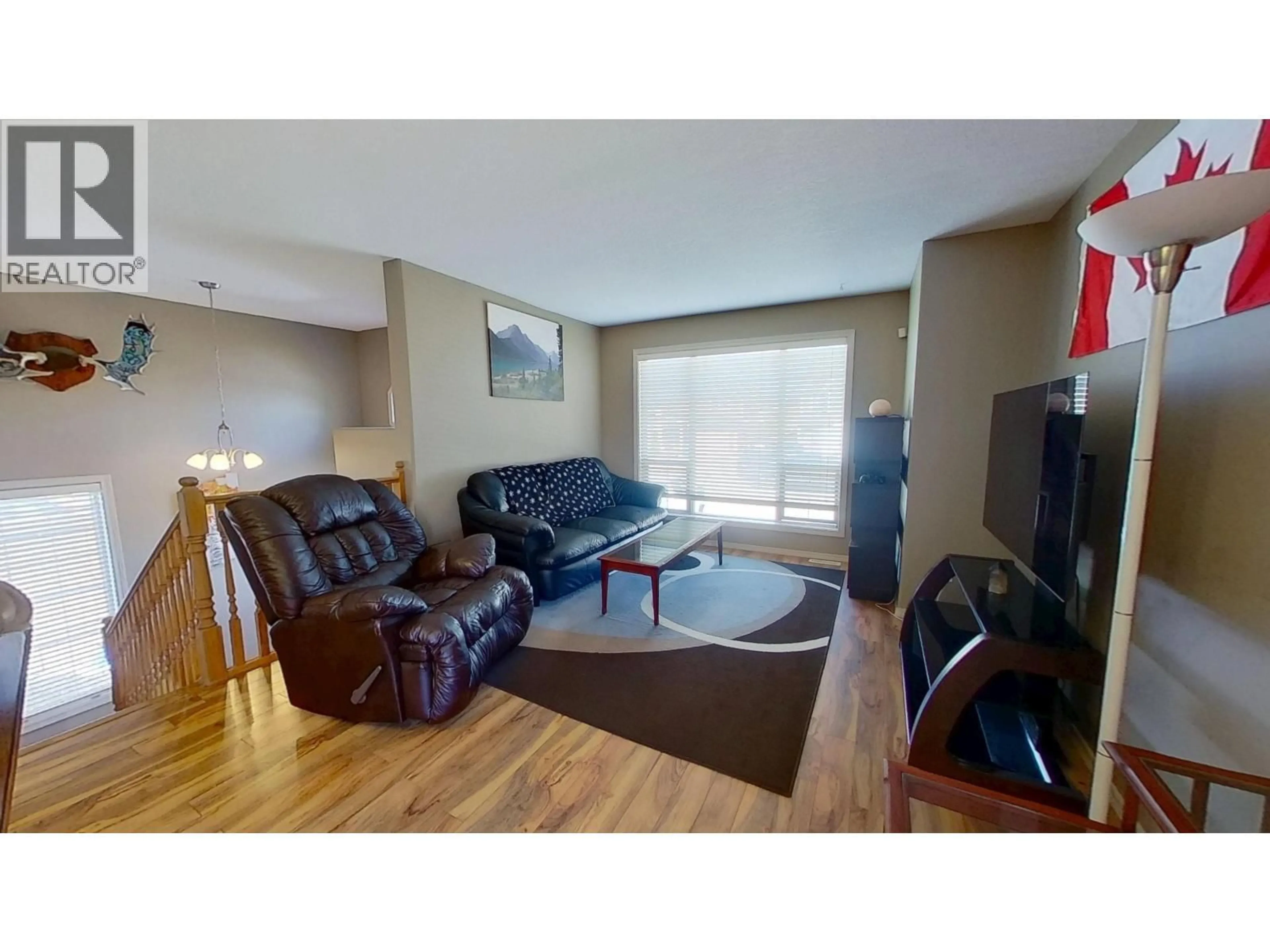 Living room with furniture, wood/laminate floor for 8307 86 AVENUE, Fort St. John British Columbia V1J0G4