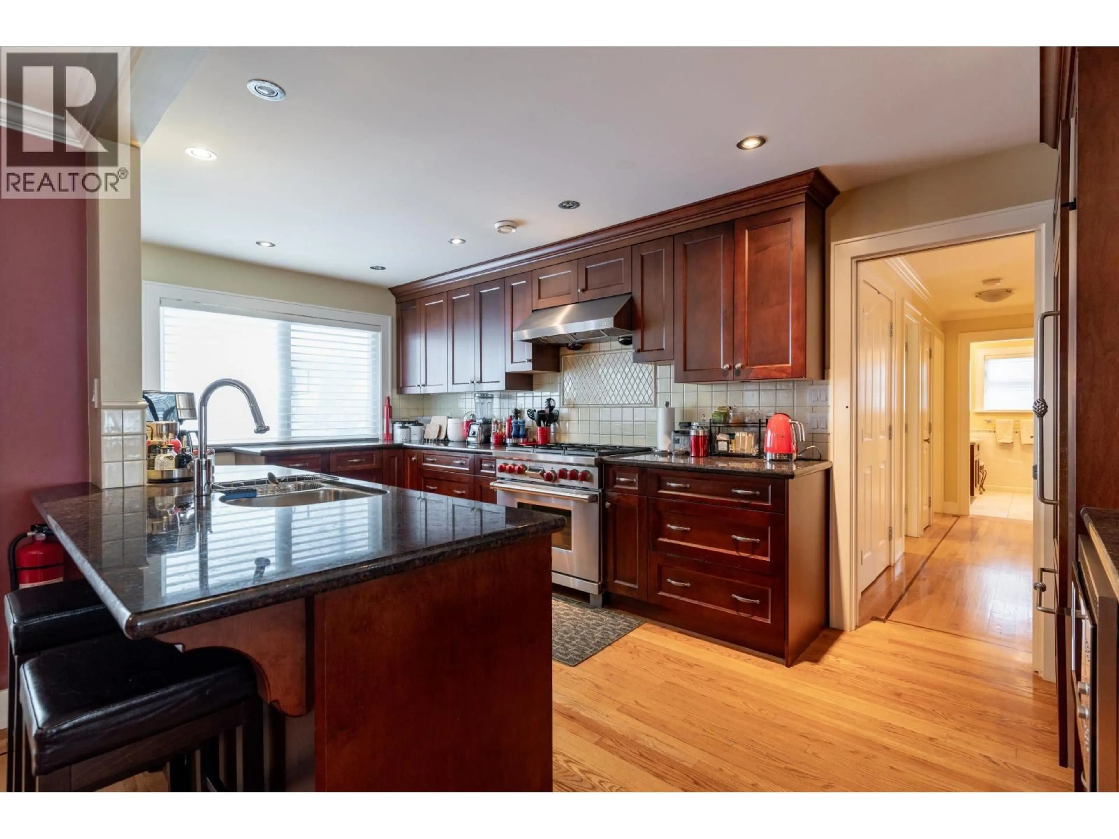 Open concept kitchen, wood/laminate floor for 5570 BAILLIE STREET, Vancouver British Columbia V5Z3M8