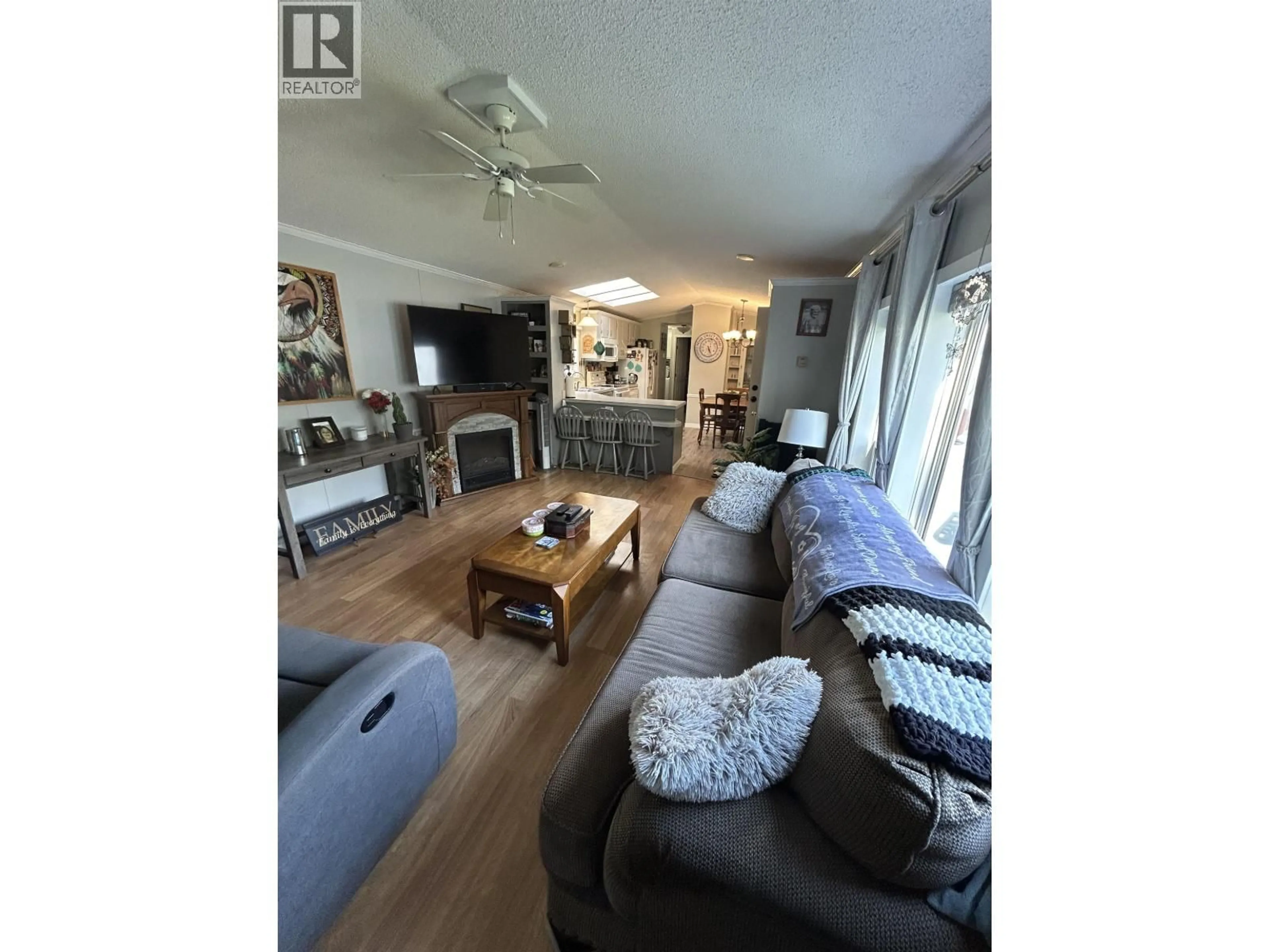 Living room with furniture, wood/laminate floor for 97 - 1000 INVERNESS ROAD, Prince George British Columbia V2K4L9