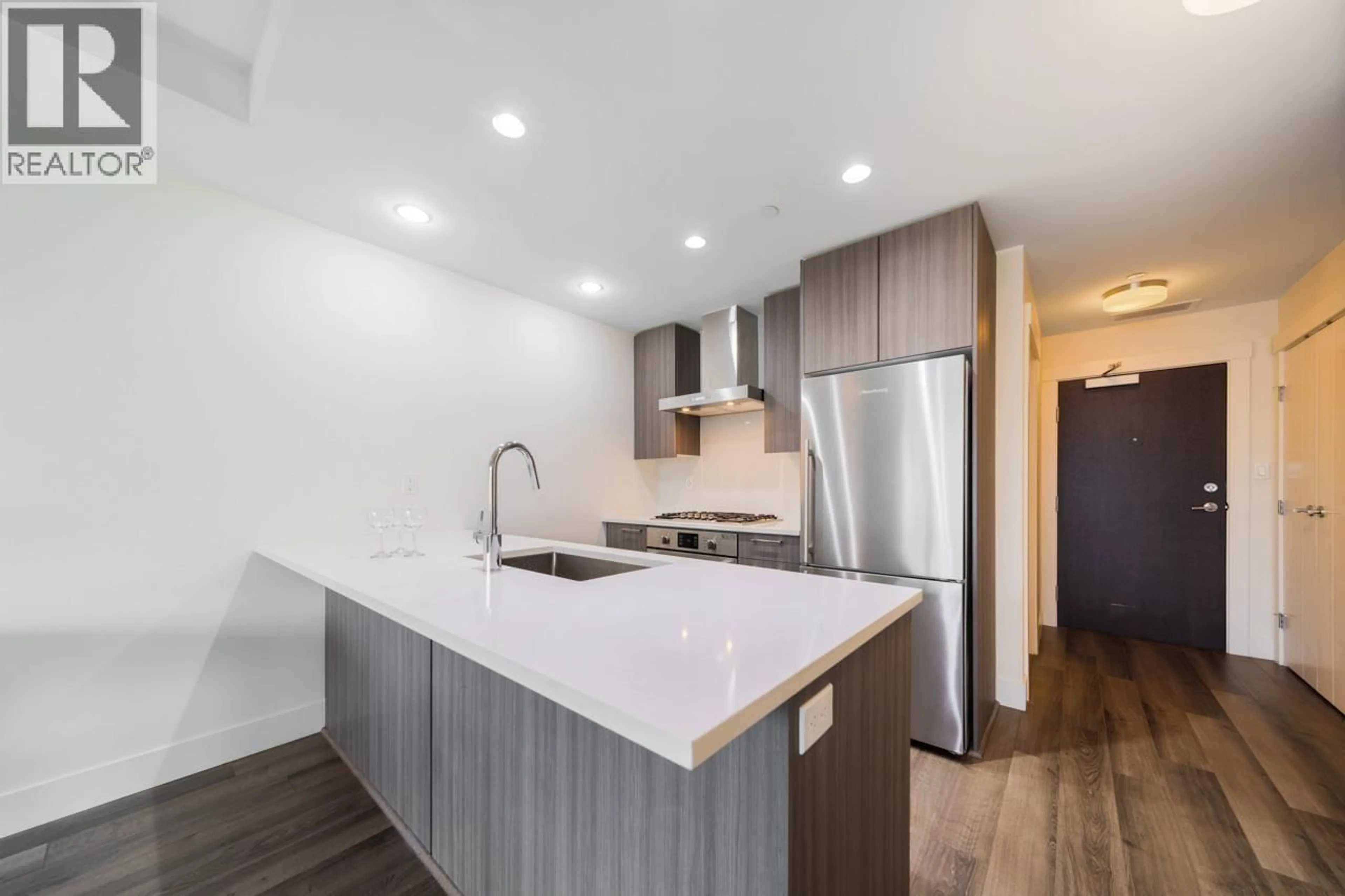 Open concept kitchen, wood/laminate floor for 311 - 10788 NO. 5 ROAD, Richmond British Columbia V6W0B7