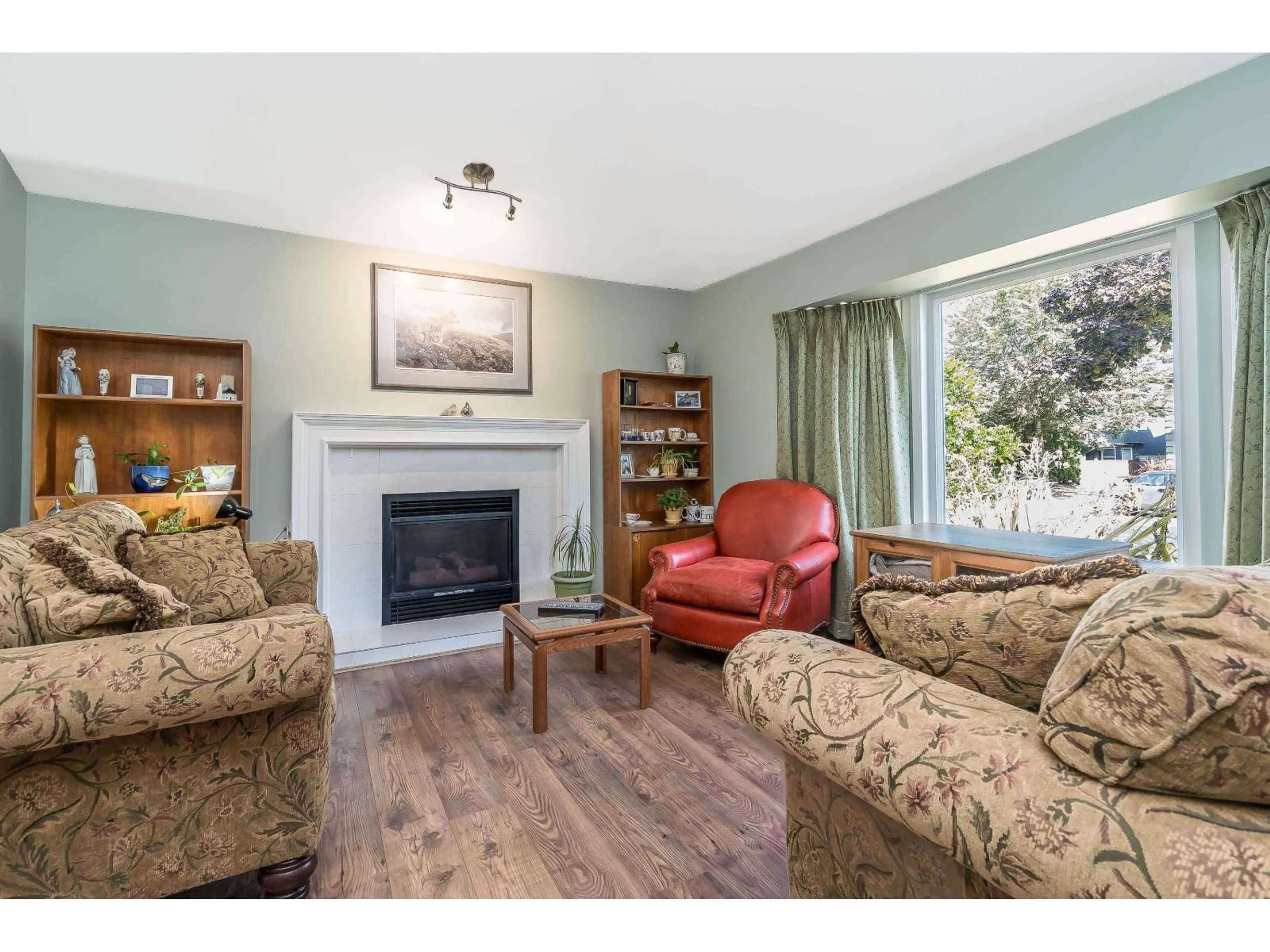 Living room with furniture, wood/laminate floor for 18156 CLAYTONWOOD CRESCENT, Surrey British Columbia V3S7T5
