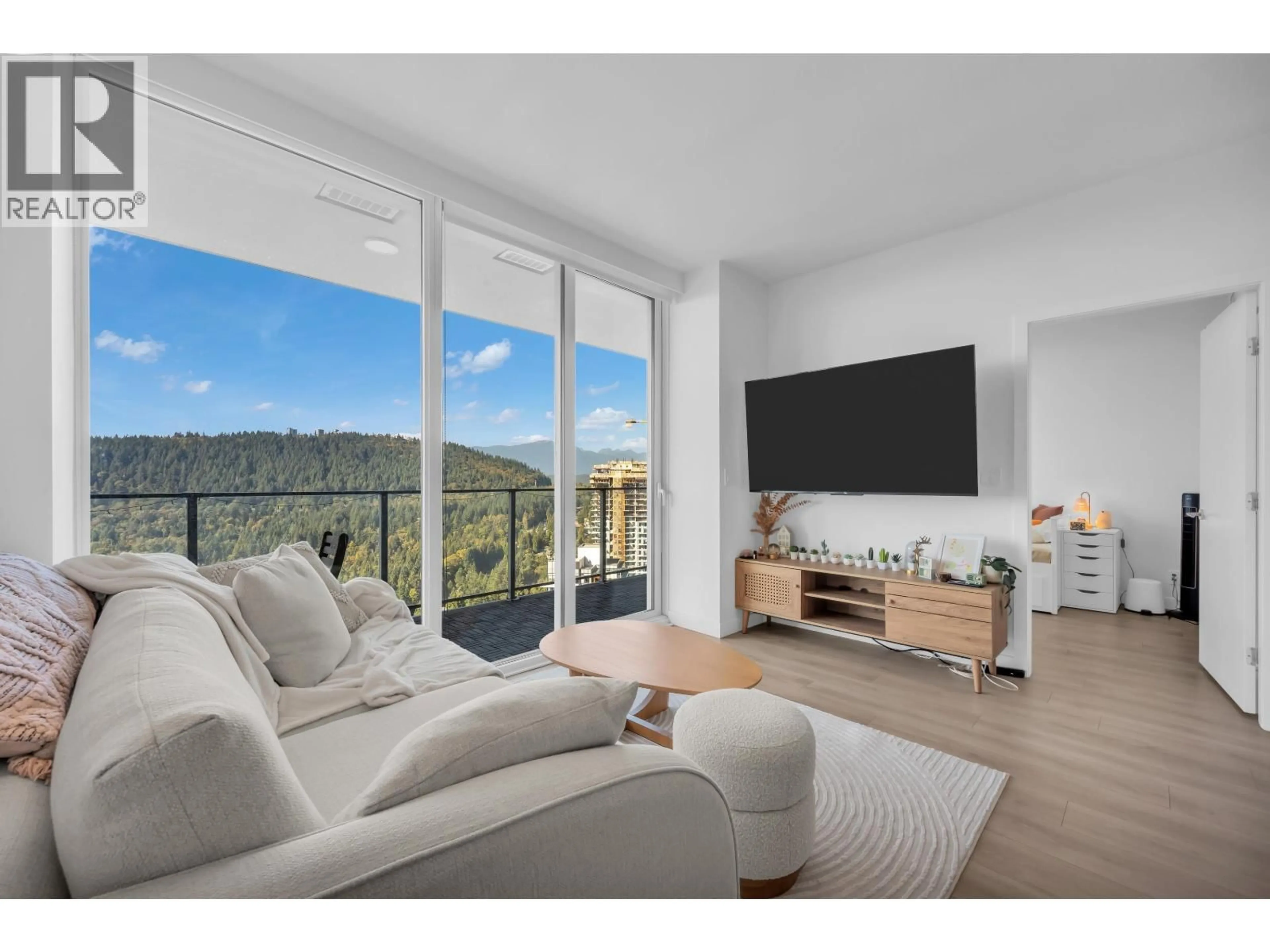 Living room with furniture, wood/laminate floor for 3202 - 567 CLARKE ROAD, Coquitlam British Columbia V3J0K7