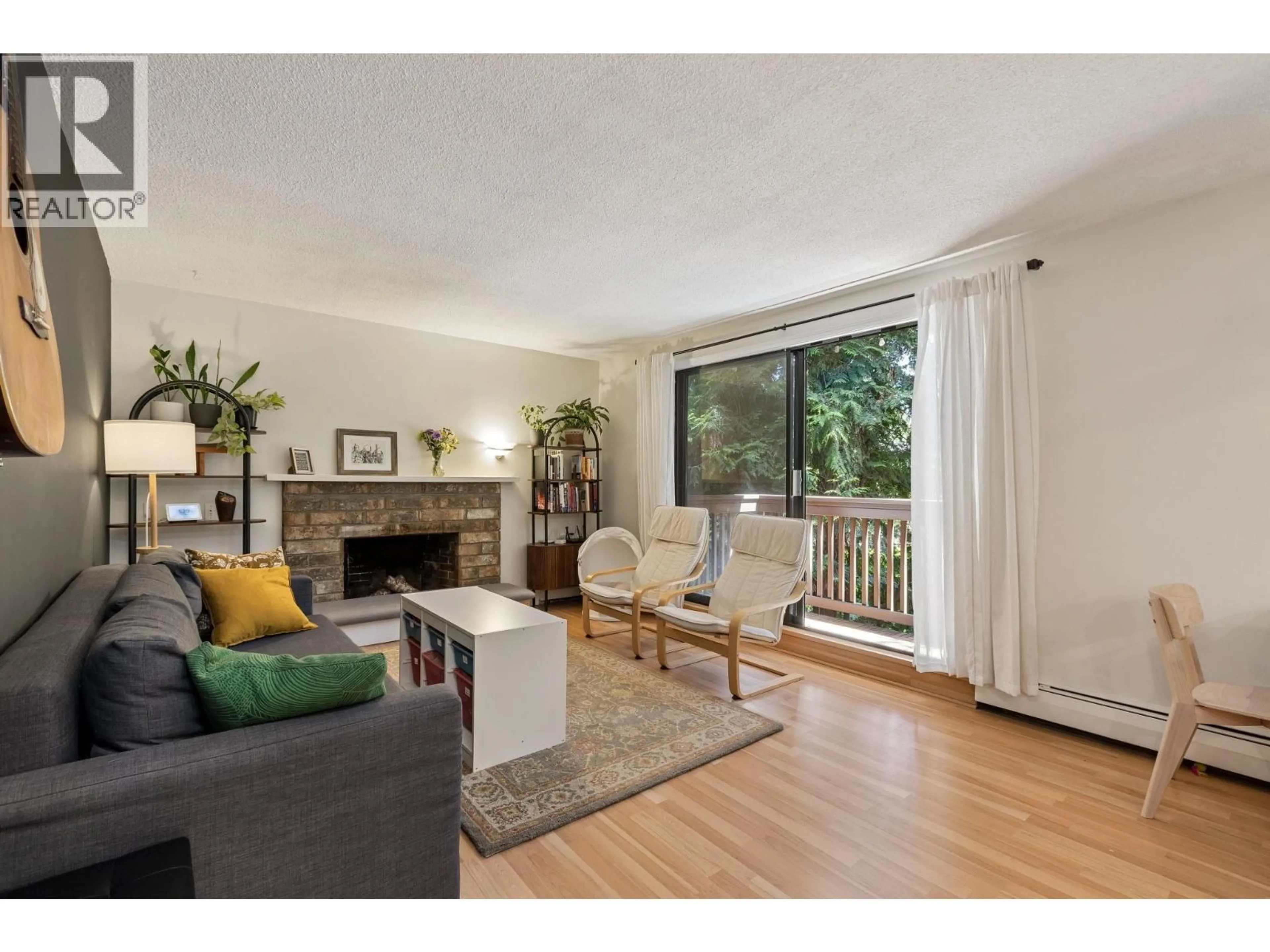 Living room with furniture, wood/laminate floor for 209 - 310 3RD STREET, North Vancouver British Columbia V7L1E9