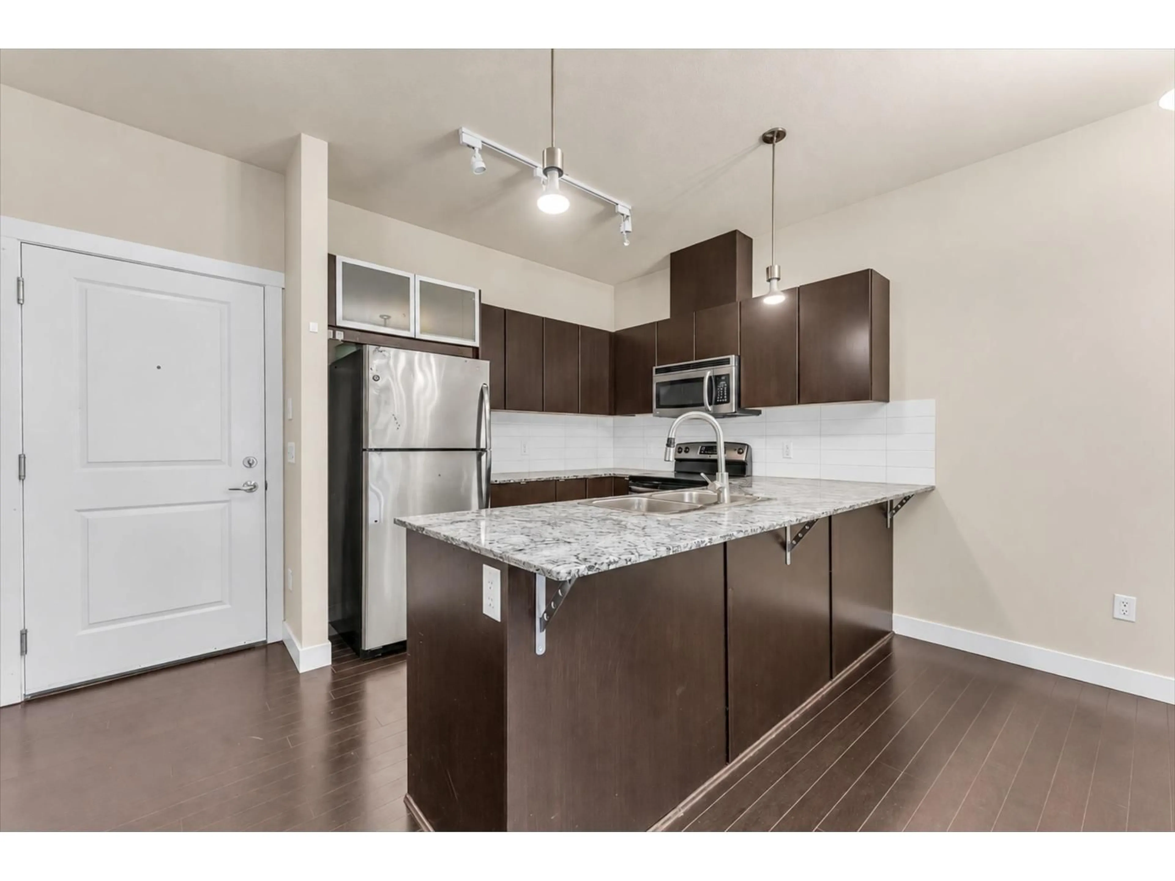 Open concept kitchen, wood/laminate floor for 409 - 9655 KING GEORGE BOULEVARD, Surrey British Columbia V3T0C7