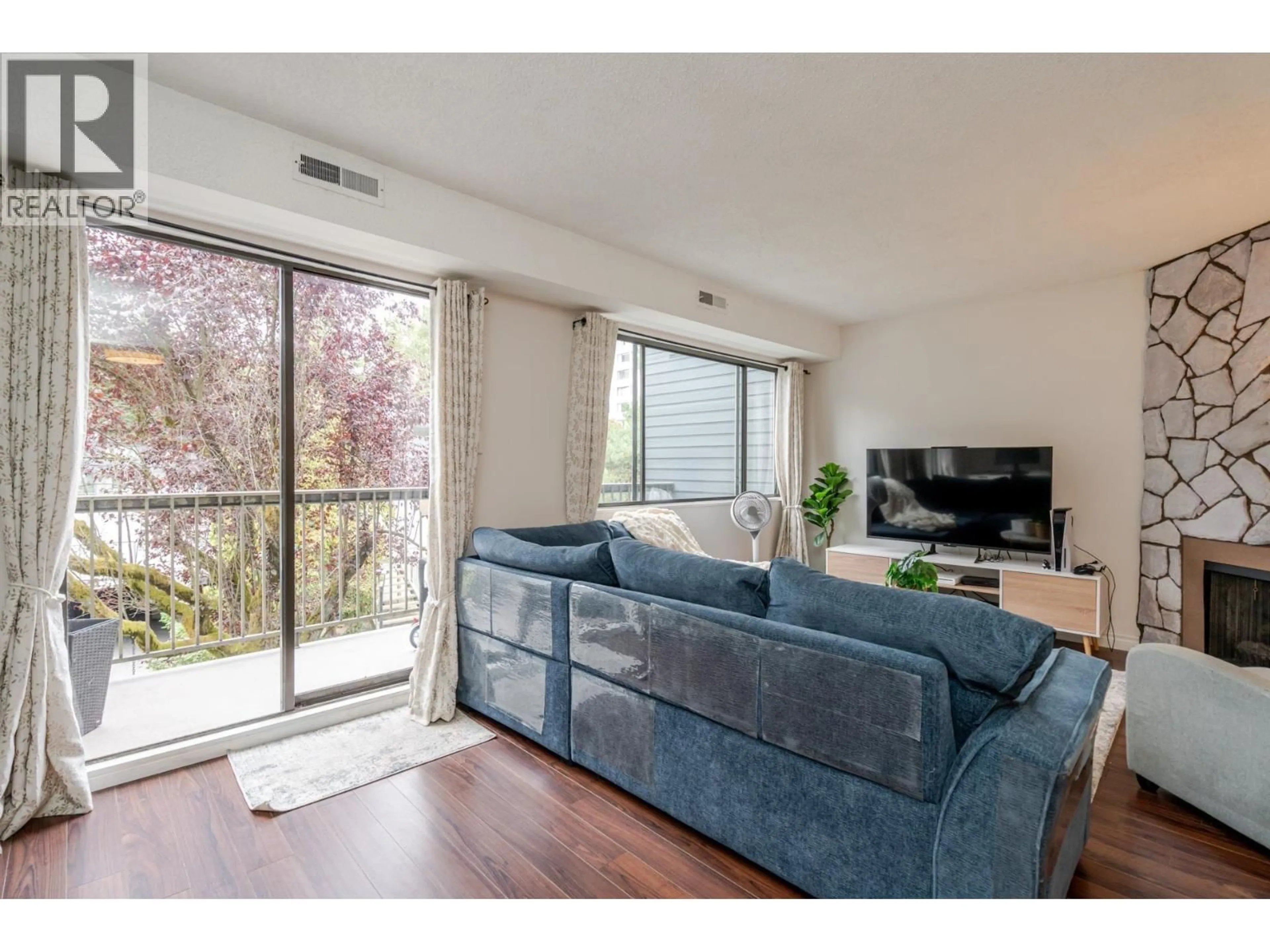 Living room with furniture, wood/laminate floor for 7363 CAPISTRANO DRIVE, Burnaby British Columbia V5A1P7