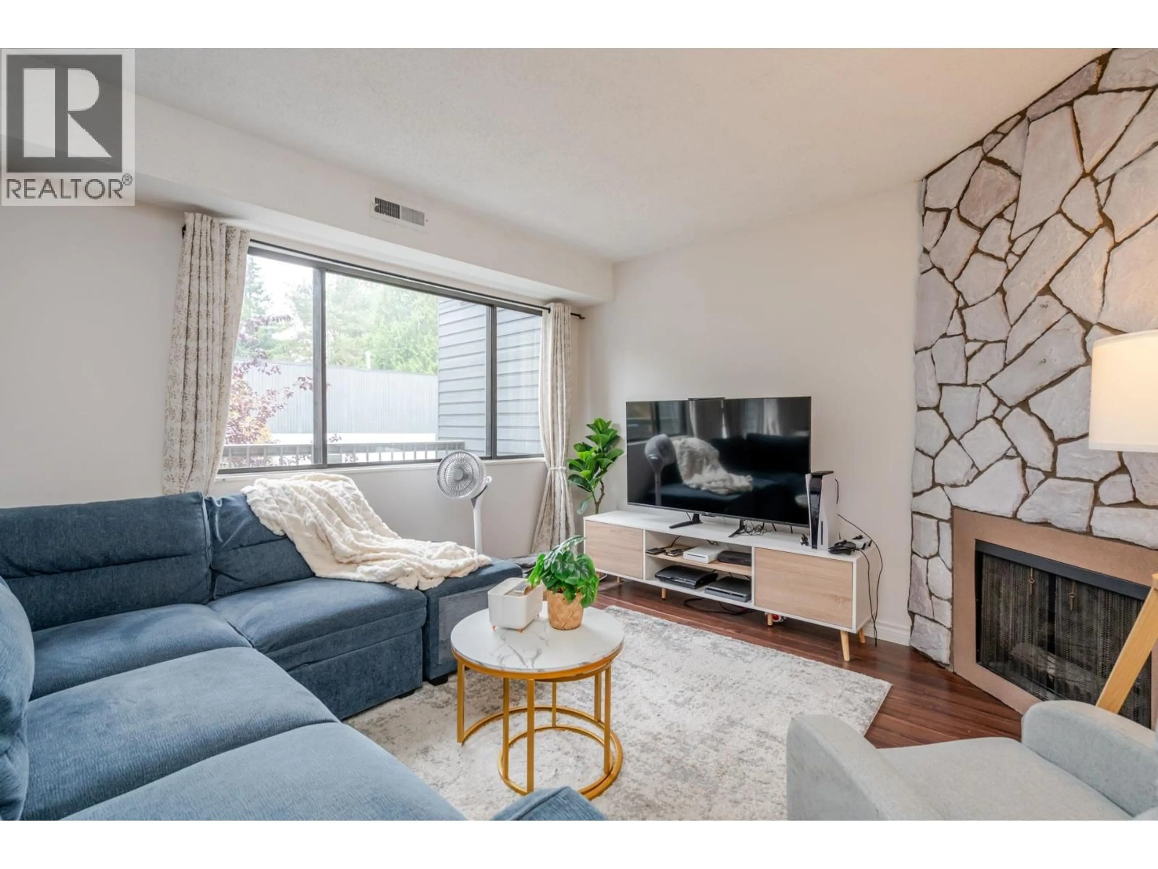 Living room with furniture, wood/laminate floor for 7363 CAPISTRANO DRIVE, Burnaby British Columbia V5A1P7