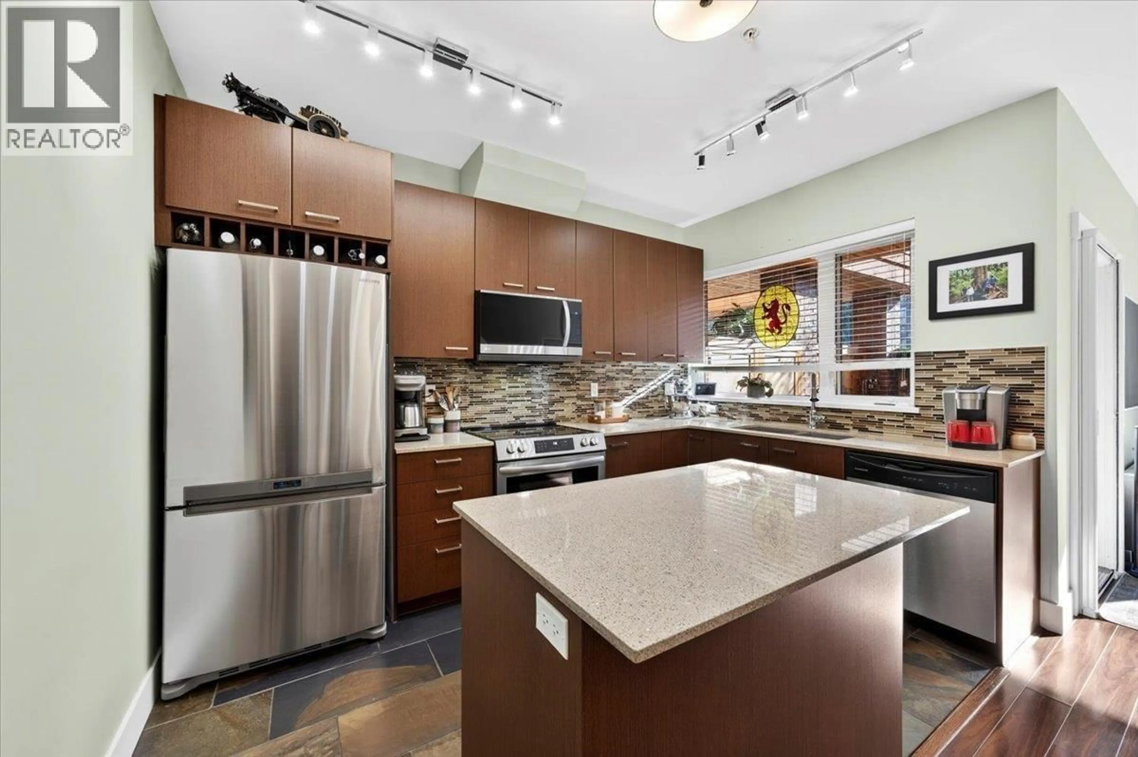 Open concept kitchen, ceramic/tile floor for 102 - 2473 ATKINS AVENUE, Port Coquitlam British Columbia V3C0C4