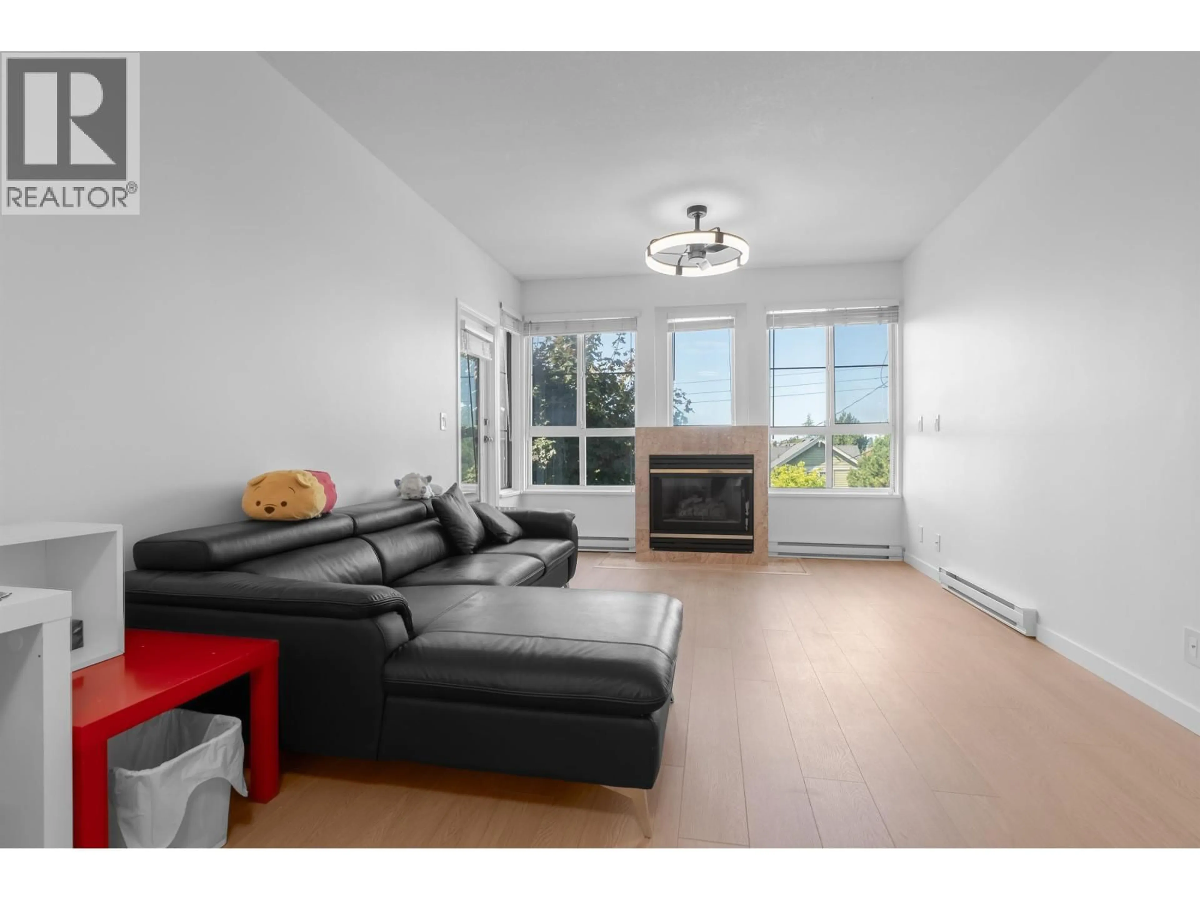 Living room with furniture, wood/laminate floor for 202 - 7300 GILBERT ROAD, Richmond British Columbia V7C3W2