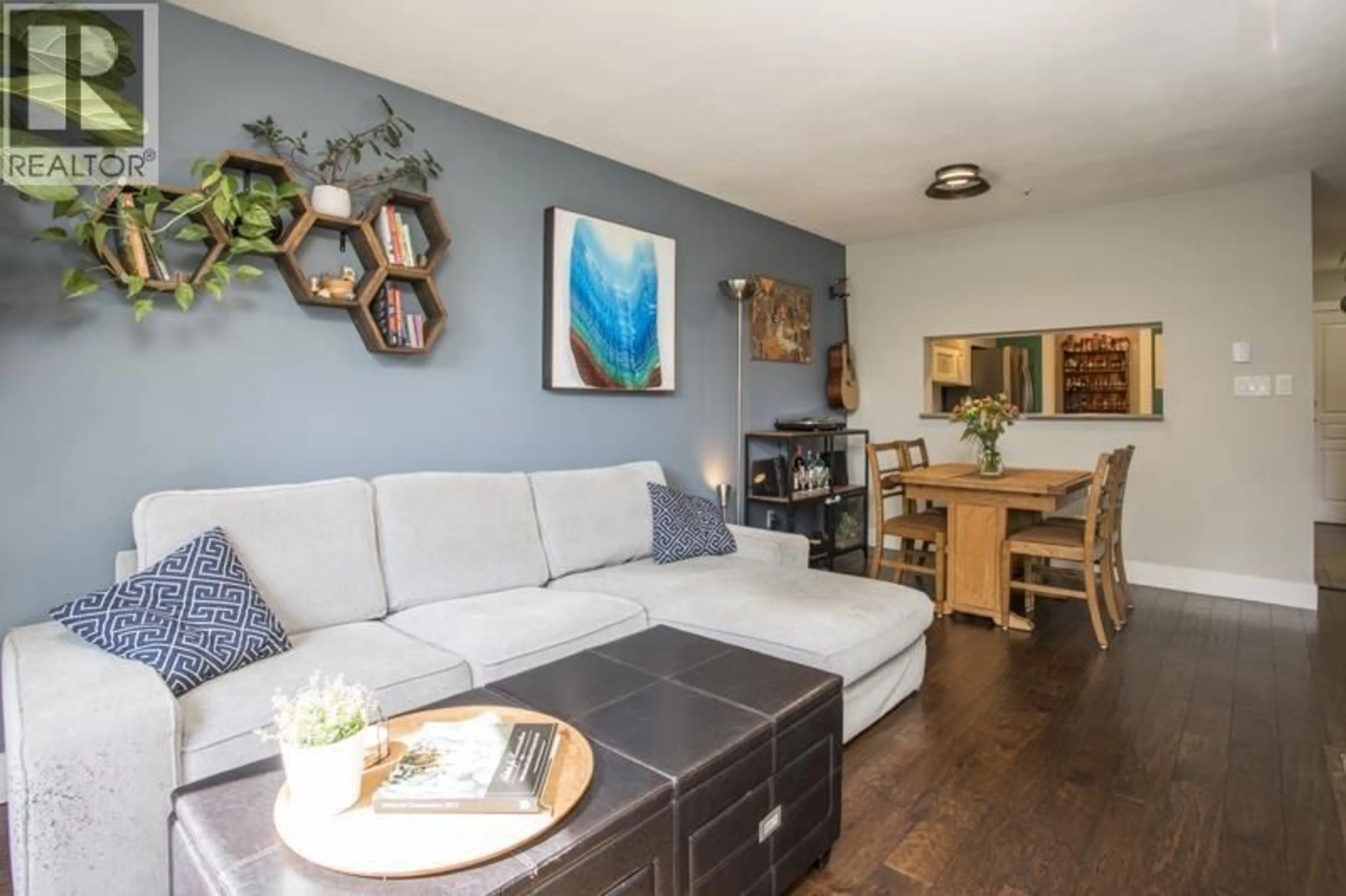 Living room with furniture, wood/laminate floor for 211 - 8460 JELLICOE STREET, Vancouver British Columbia V5S4S8