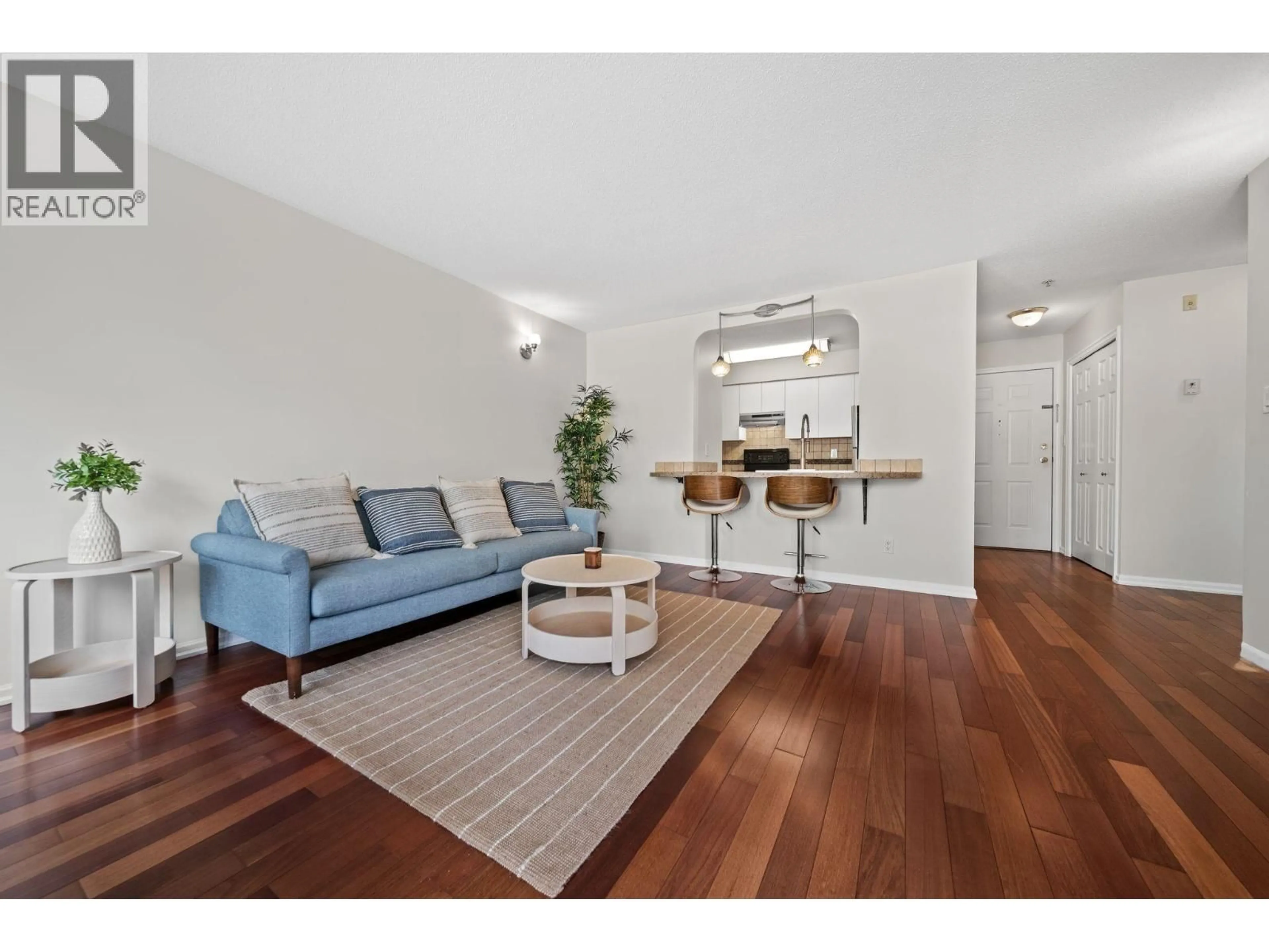 Living room with furniture, wood/laminate floor for 201 - 4990 MCGEER STREET, Vancouver British Columbia V5R6C1
