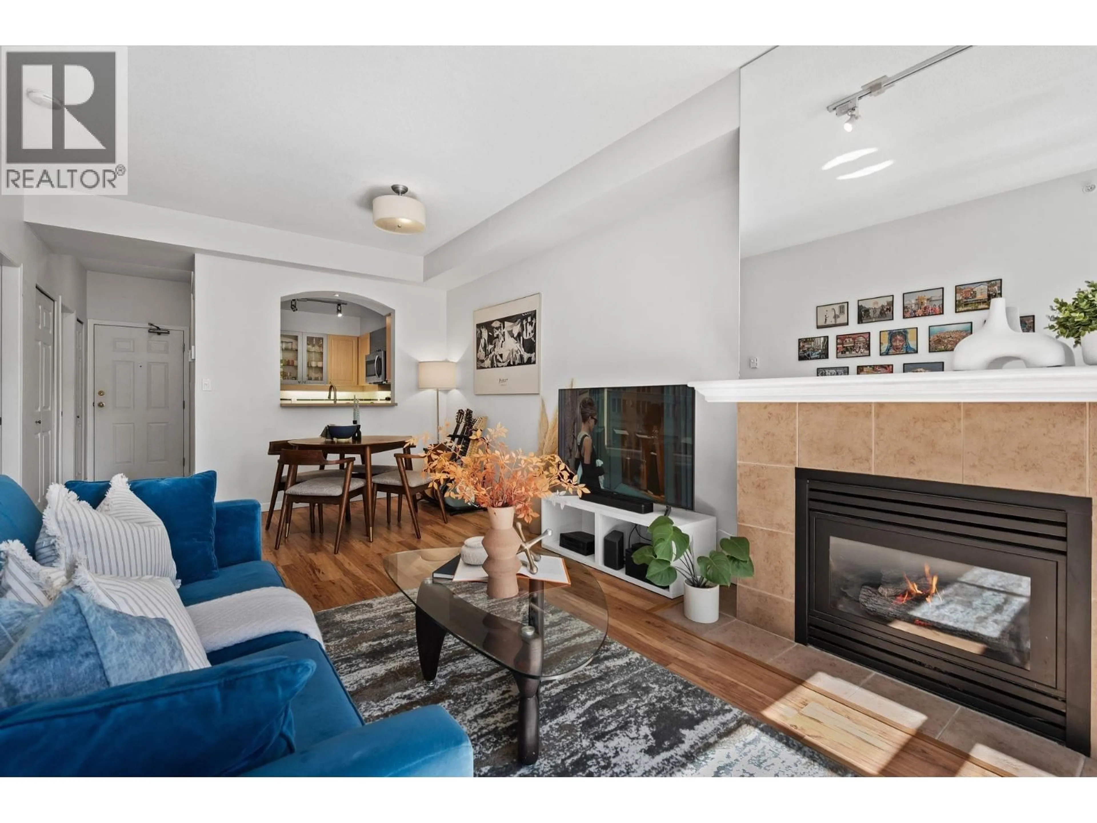 Living room with furniture, wood/laminate floor for 307 - 3600 WINDCREST DRIVE, North Vancouver British Columbia V7G2S5