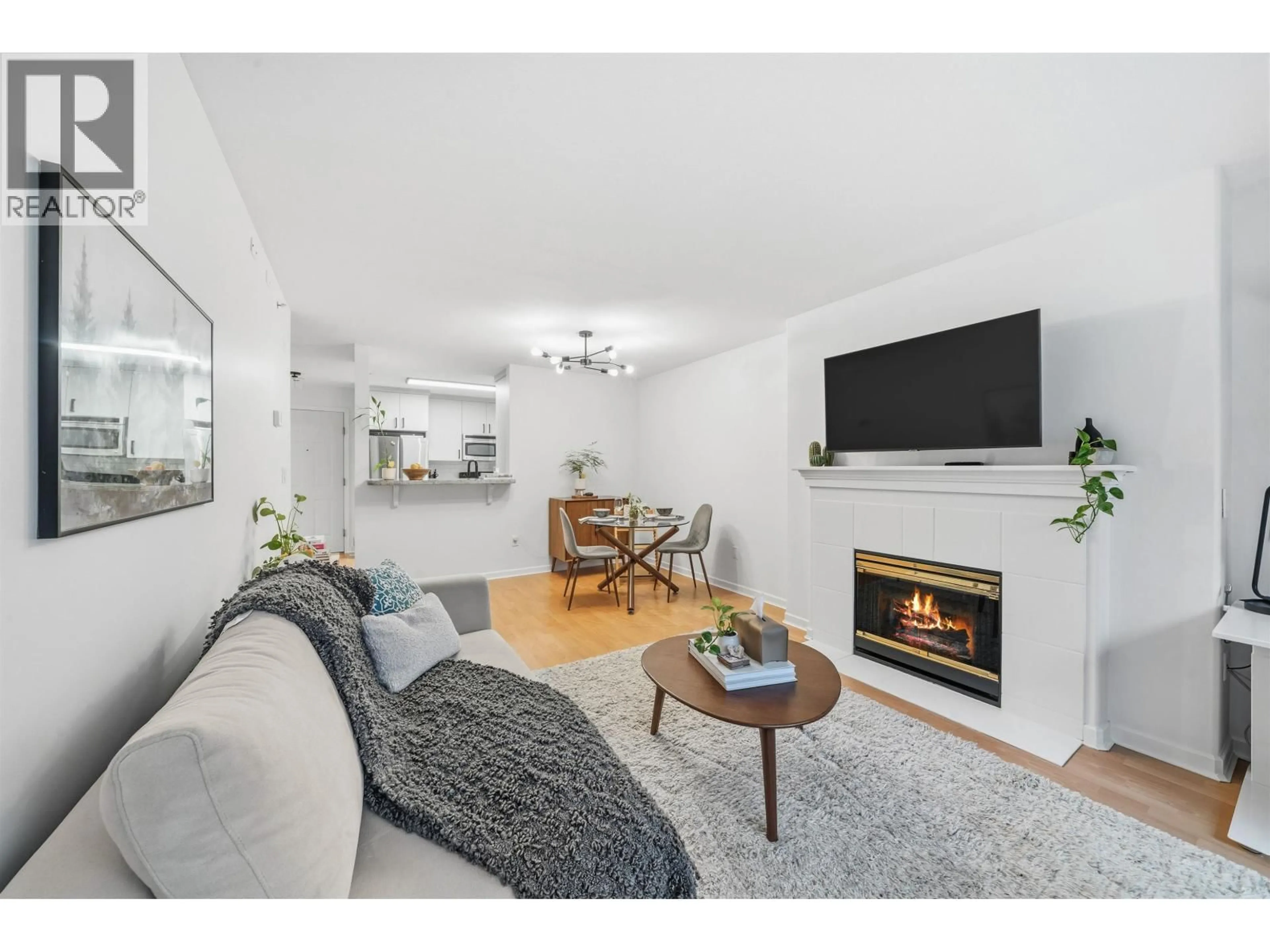 Living room with furniture, wood/laminate floor for 210 - 5281 OAKMOUNT CRESCENT, Burnaby British Columbia V5H4S7