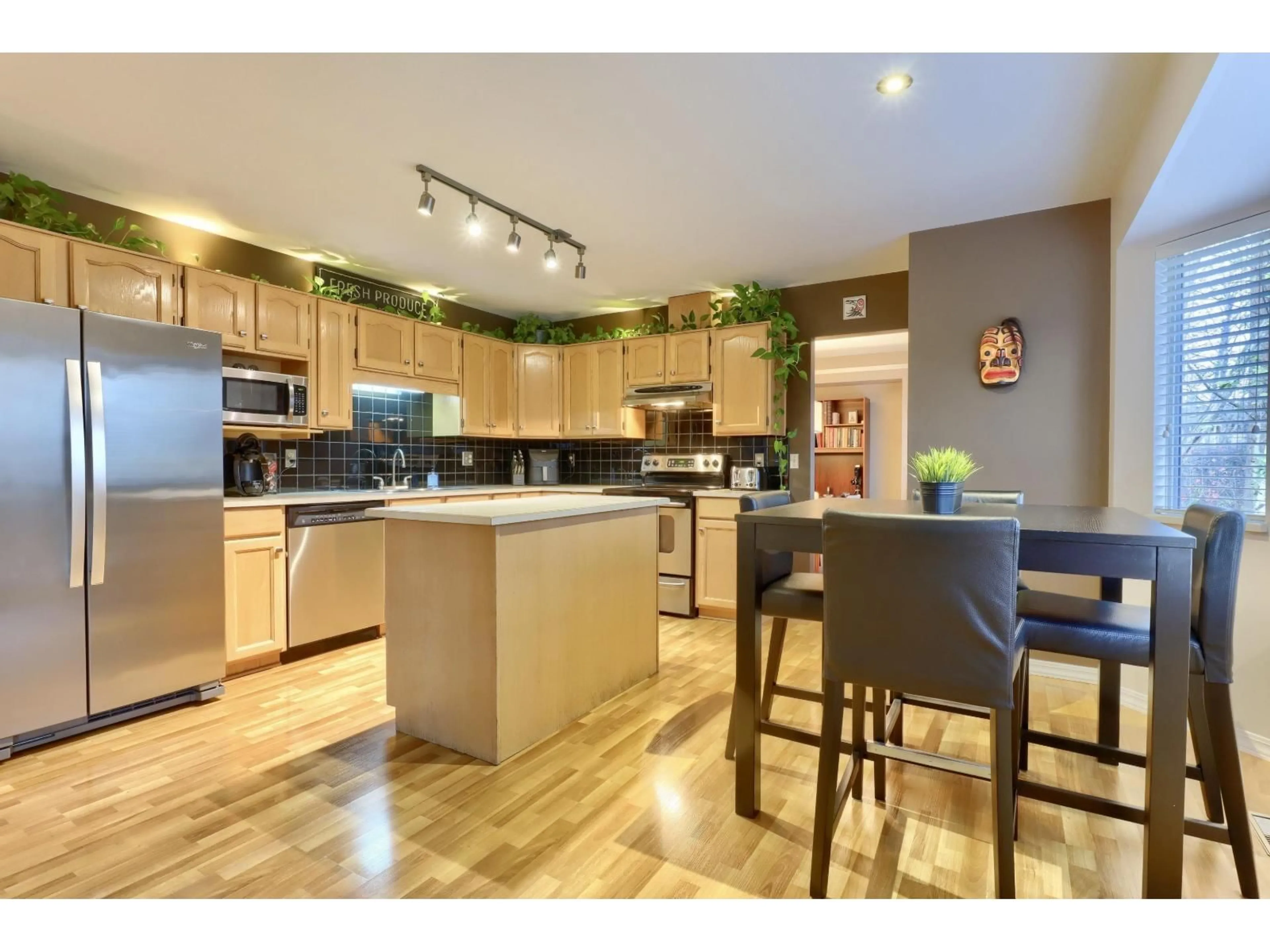 Open concept kitchen, wood/laminate floor for 8832 143 STREET, Surrey British Columbia V3V7T2