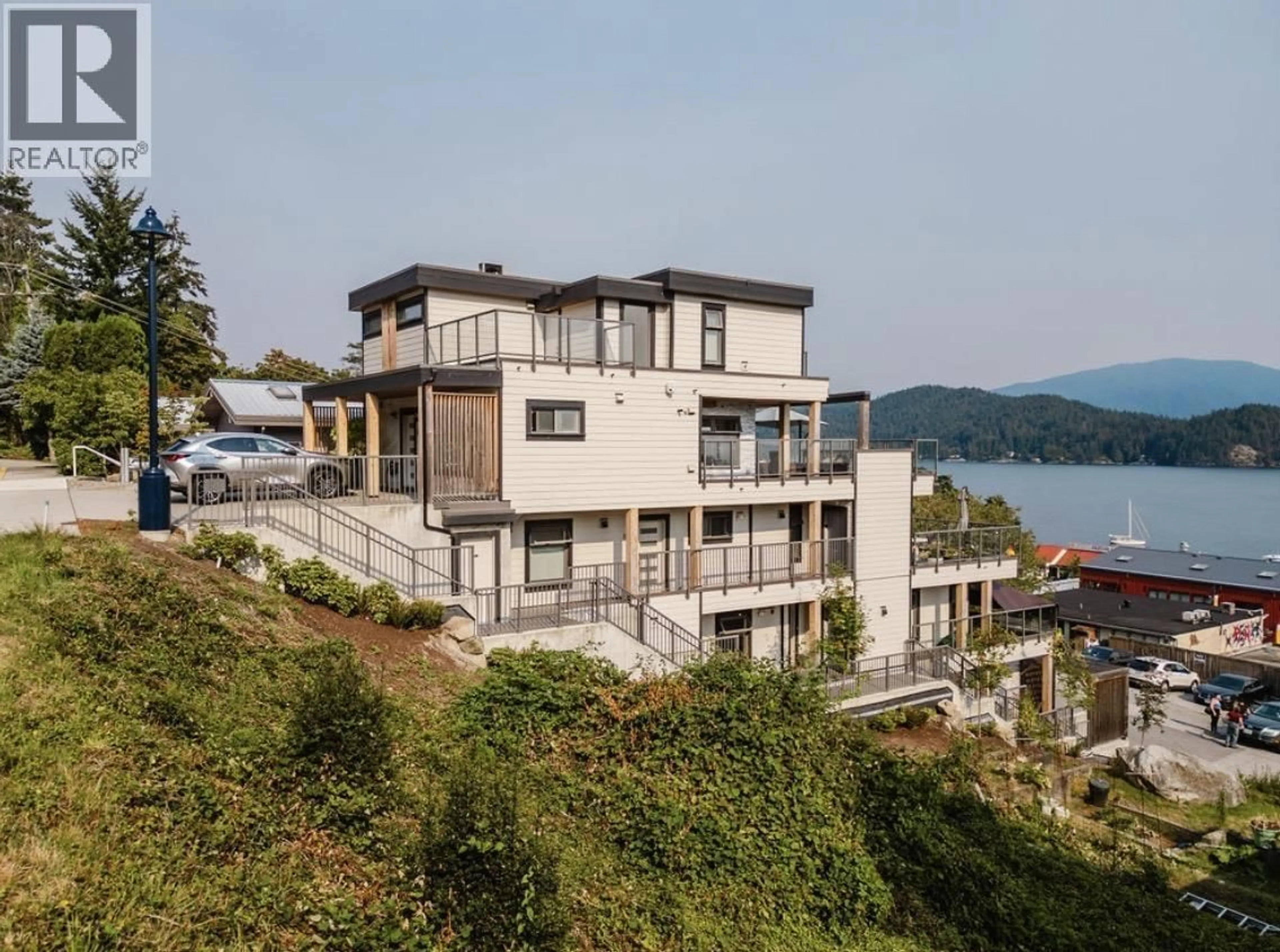 A pic from outside/outdoor area/front of a property/back of a property/a pic from drone, water/lake/river/ocean view for 102 - 524 FLETCHER ROAD, Gibsons British Columbia V0N1V0