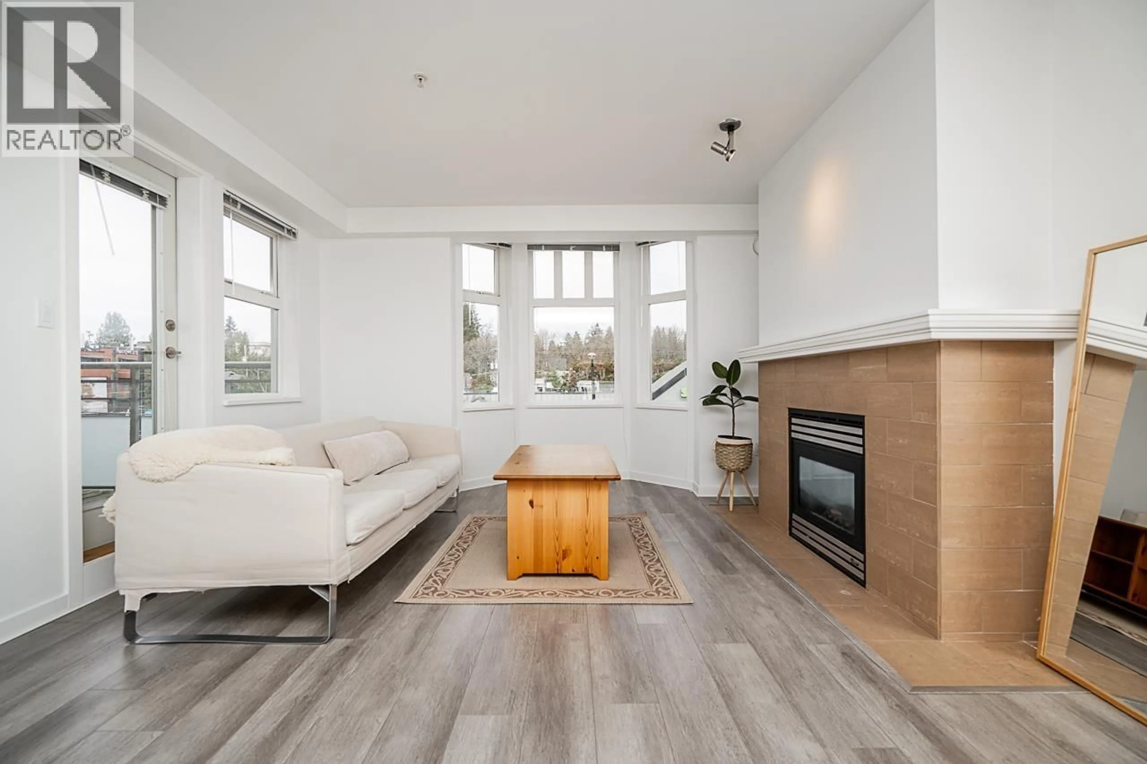 Living room with furniture, wood/laminate floor for 306 - 3580 41ST AVENUE, Vancouver British Columbia V6N3E6