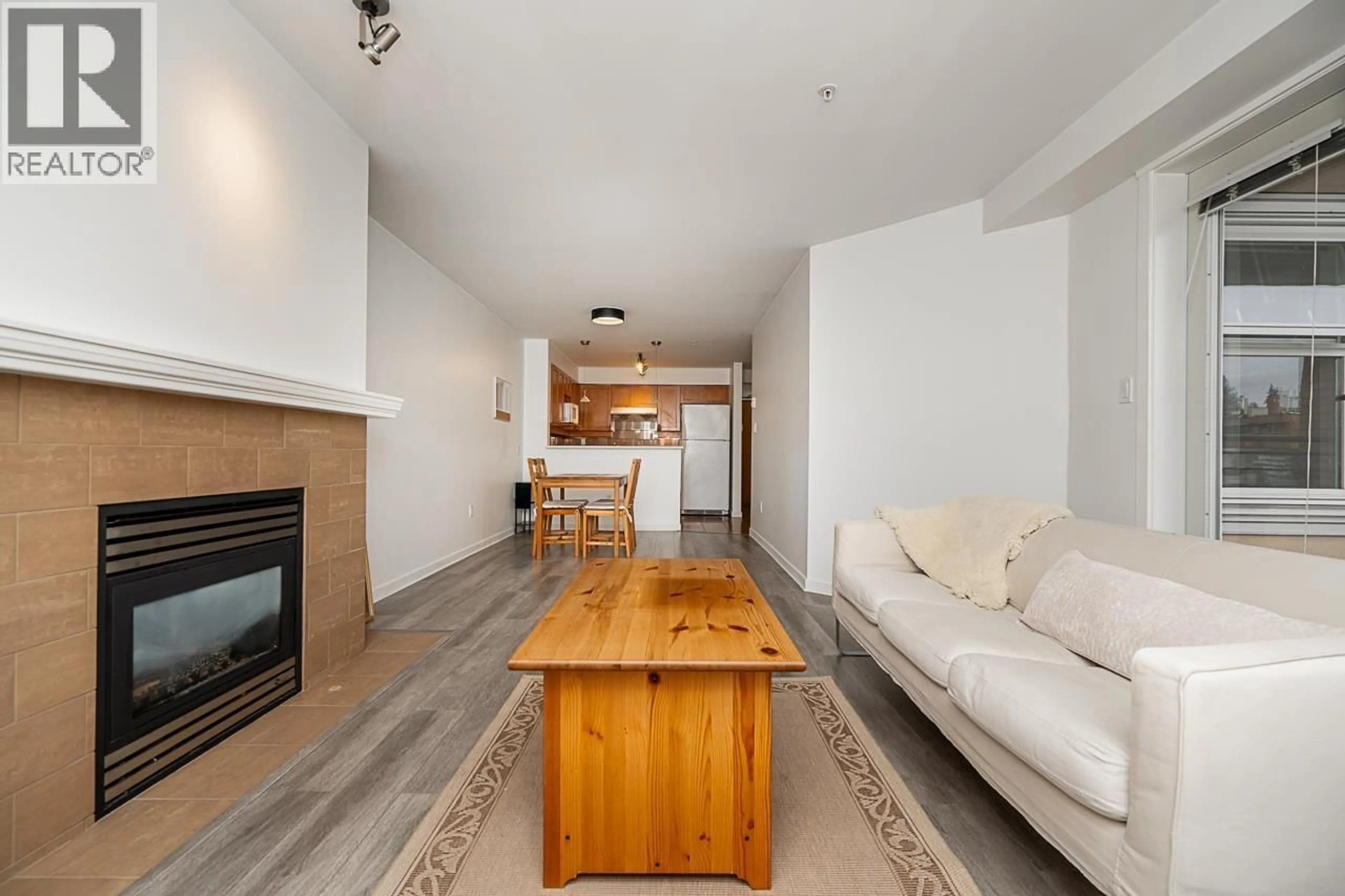 Living room with furniture, wood/laminate floor for 306 - 3580 41ST AVENUE, Vancouver British Columbia V6N3E6